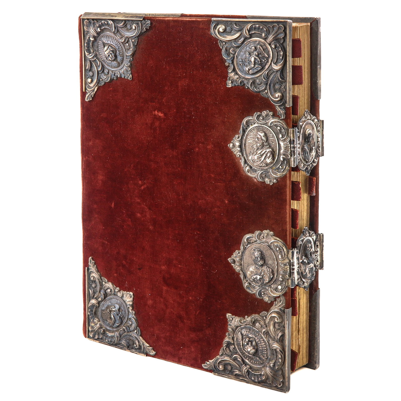 A Missal: With red velvet and silver-tested reliefs of sacred figures, 7 x 36 x 25 cm.