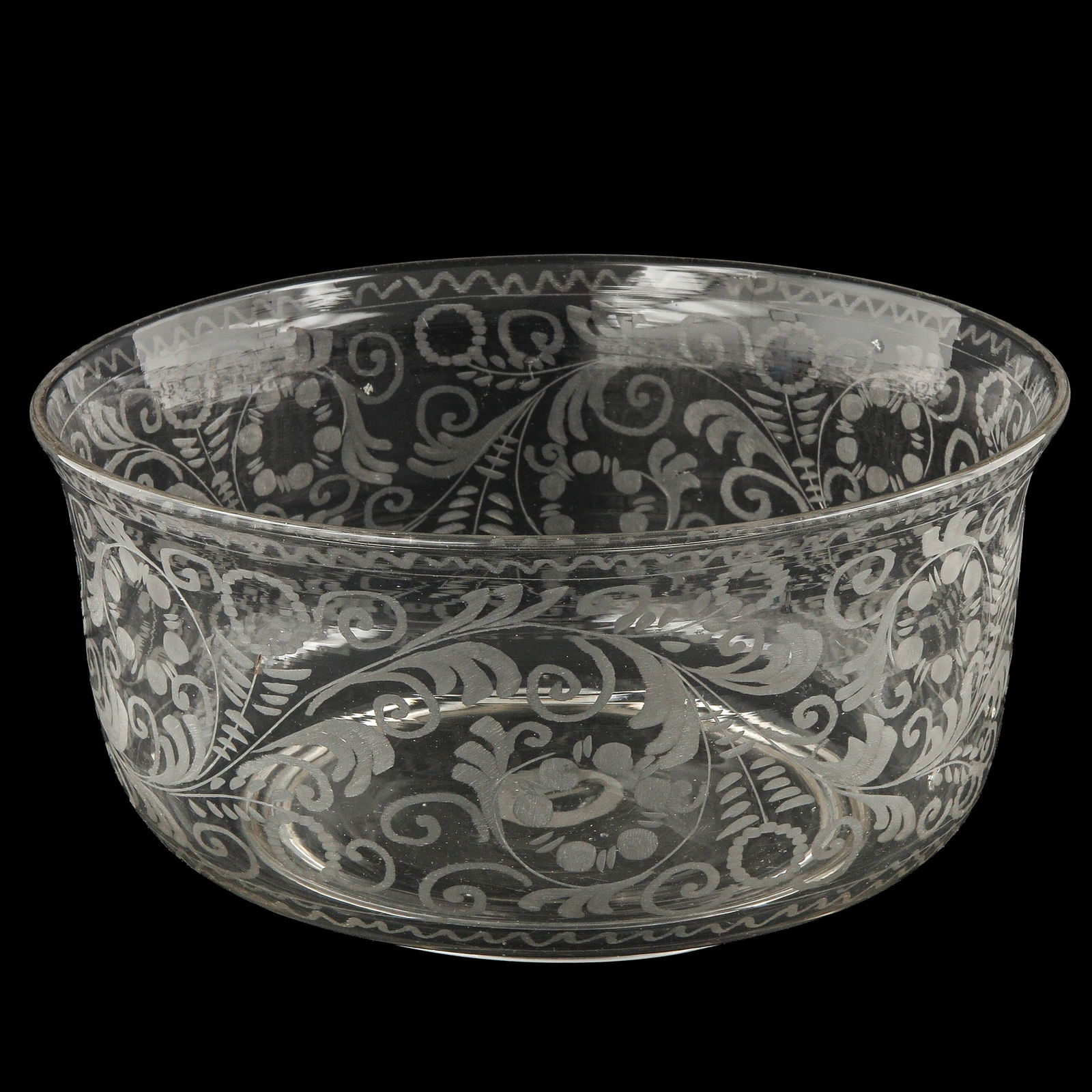 An Engraved Glass Bowl: Engraved with a curly floral decoration all around, diameter 22 cm.