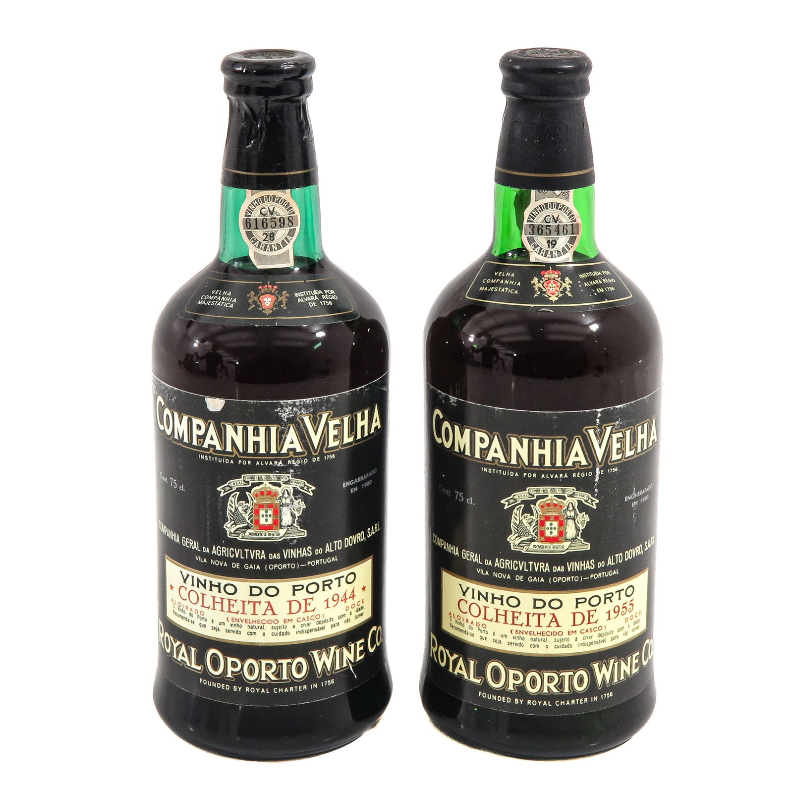A Lot of 2 Bottles of Port: Set of 2 Port bottles, consisting of one 1944 and one 1955 bottle, Royal Oporto Wine Co., labels state Companhia Velha and feature the Portuguese coat of arms, height 26 cm.