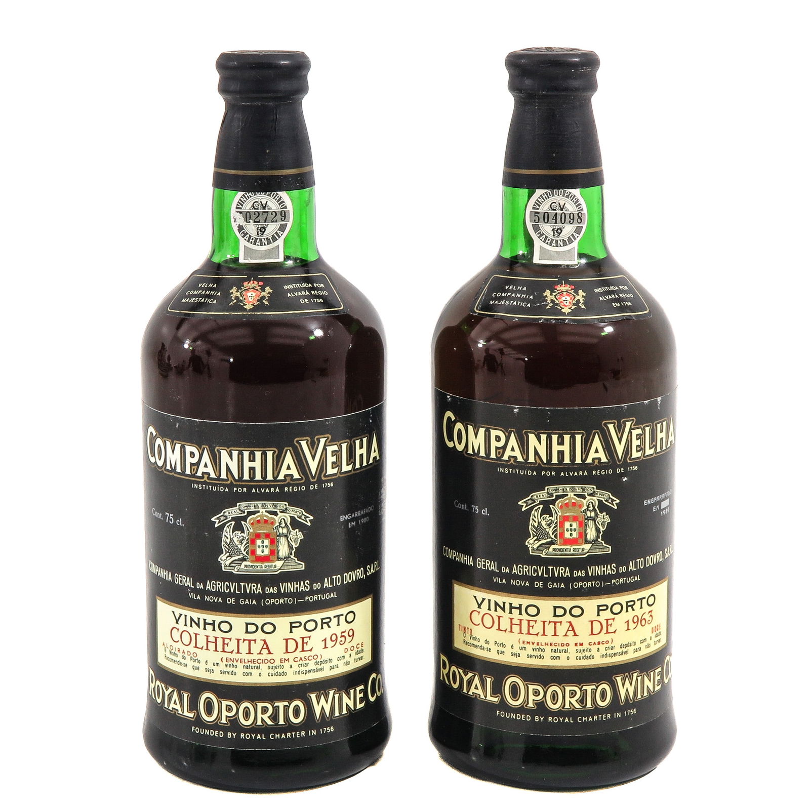 A Lot of 2 Bottles of Port: Set of 2 Port bottles, consisting of one 1959 and one 1963 bottle, Royal Oporto Wine Co., Vinho do Porto, labels state Companhia Velha and feature the Portuguese coat of arms, height 26 cm.