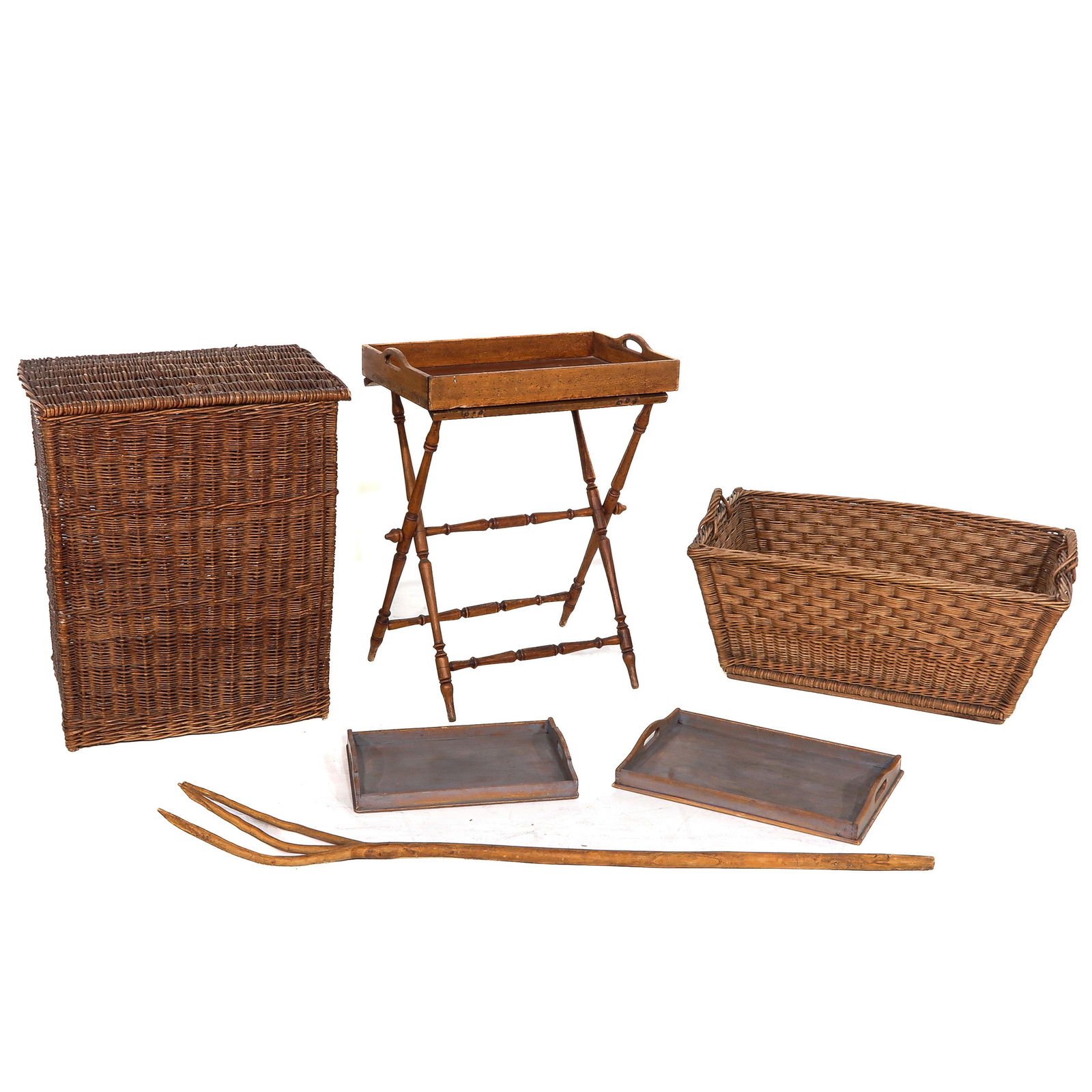 A Diverse Group of Items: Consisting of wicker baskets, a folding wooden tray stand with tray, two serving trays, and a wooden pitchfork. Largest basket: 63 x 75 x 47 cm.