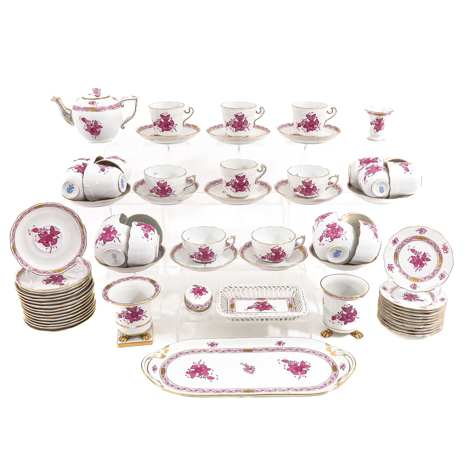 A Herend Service: Herend, Hungary, hand-painted with pink flowers, including a serving dish, length 37 cm.