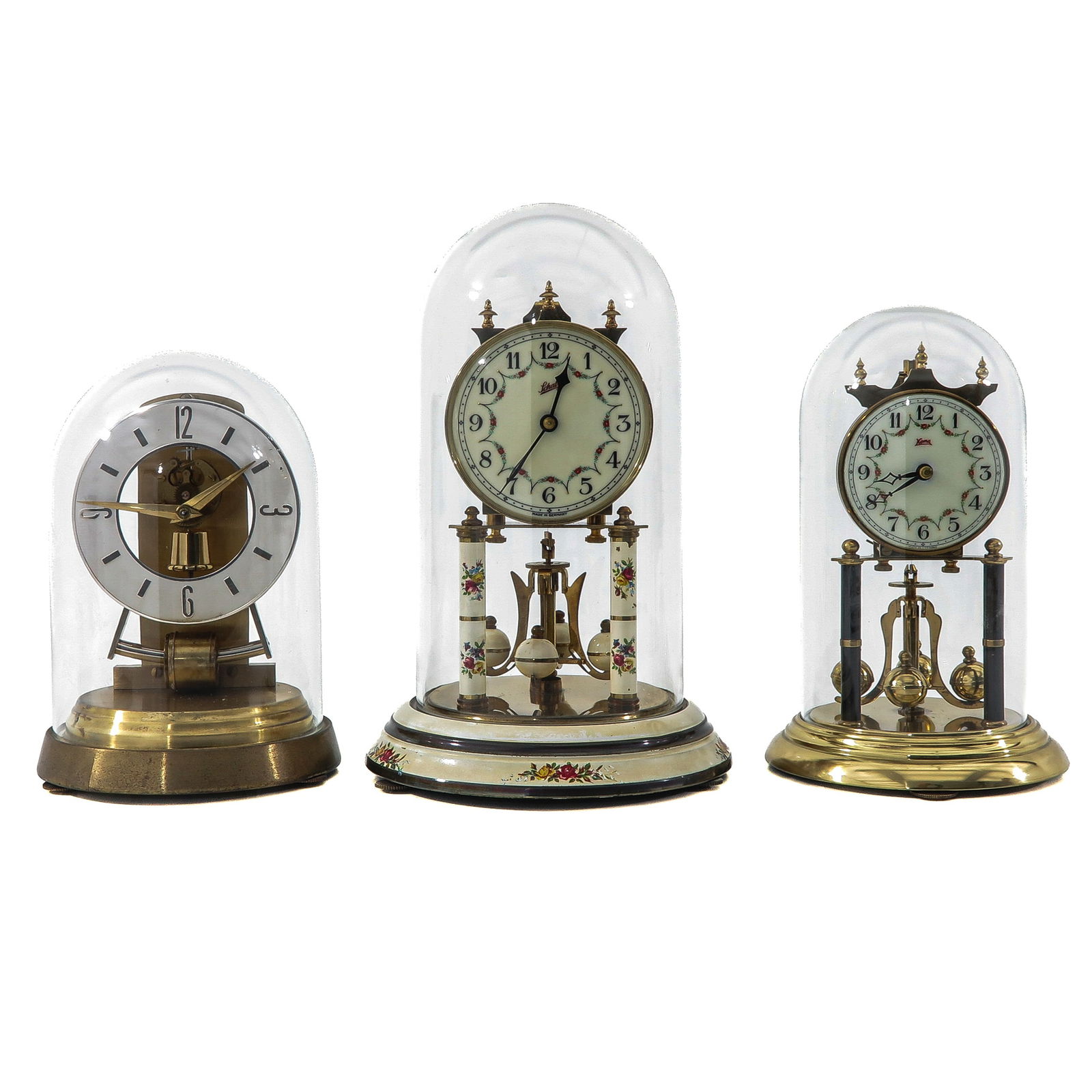 A Group of 3 Table Clocks: Consisting of three bell-jar clocks under glass bell-jars, including a year clock signed Schatz, tallest 30 cm.