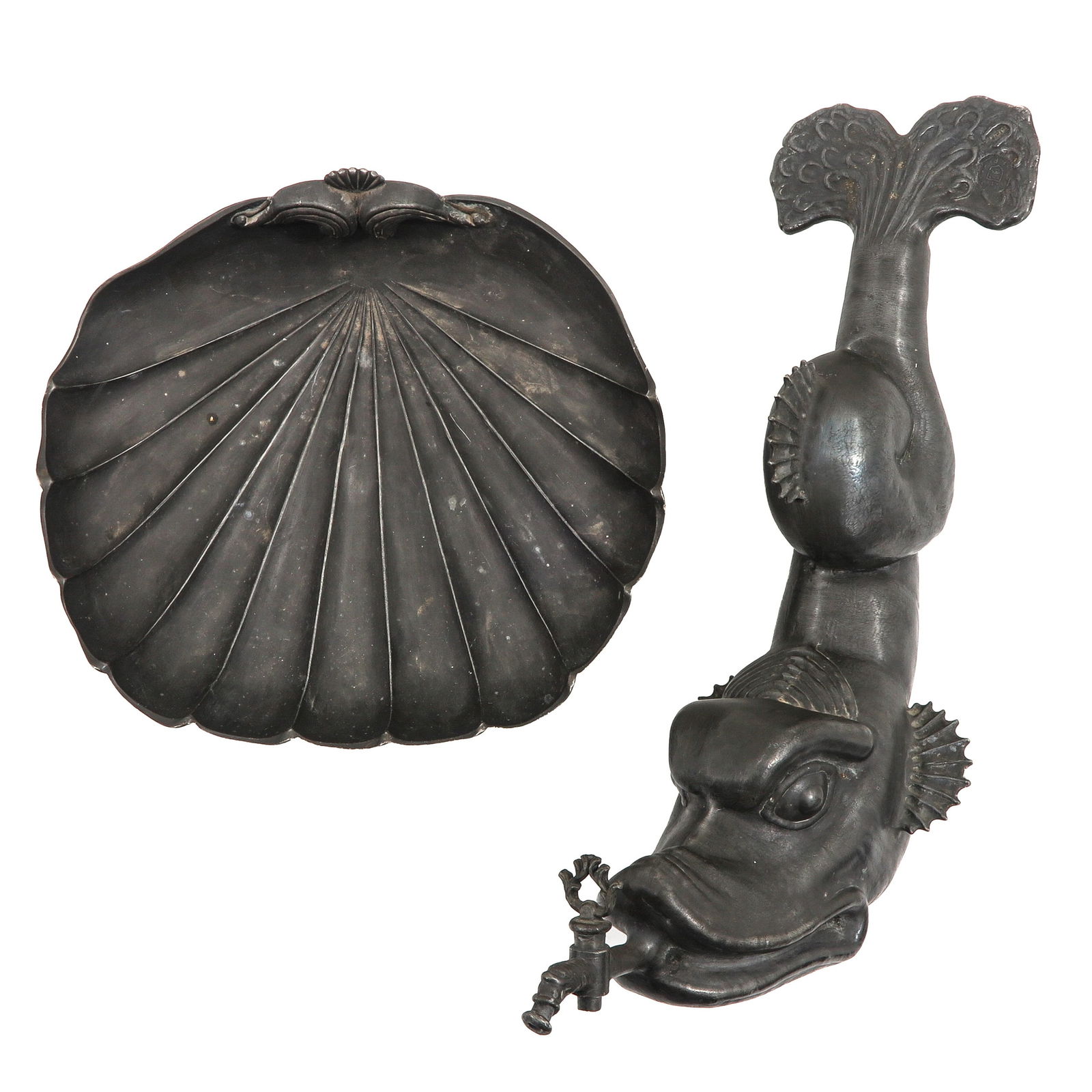 A Fountain: Pewter, hung for 110 years on the wall of the servants' room in the left spire of Chateau Noisy in Belgium, in the shape of a dolphin with a spout, height 39 cm.