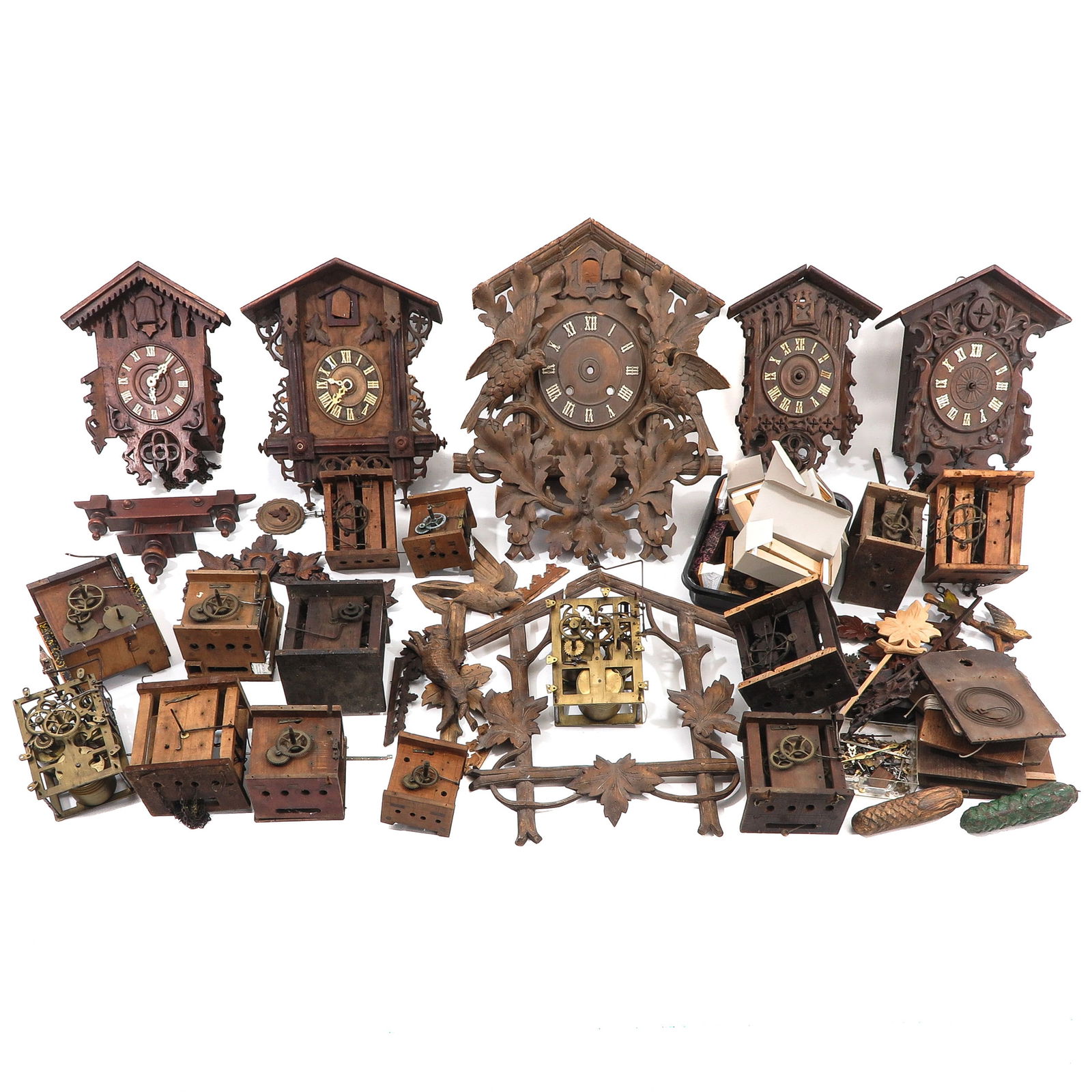 A Group of Cukoo Clocks and Parts: consisting of cuckoo clocks and parts, Germany, ca. 1900, tallest 53 cm.