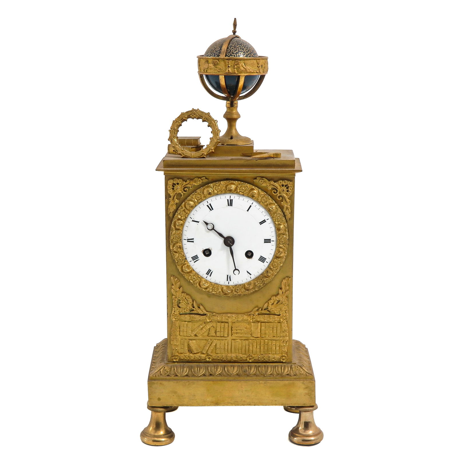 An Empire Period Pendule: Empire period, gilt bronze, topped with a globe, height 38 cm.