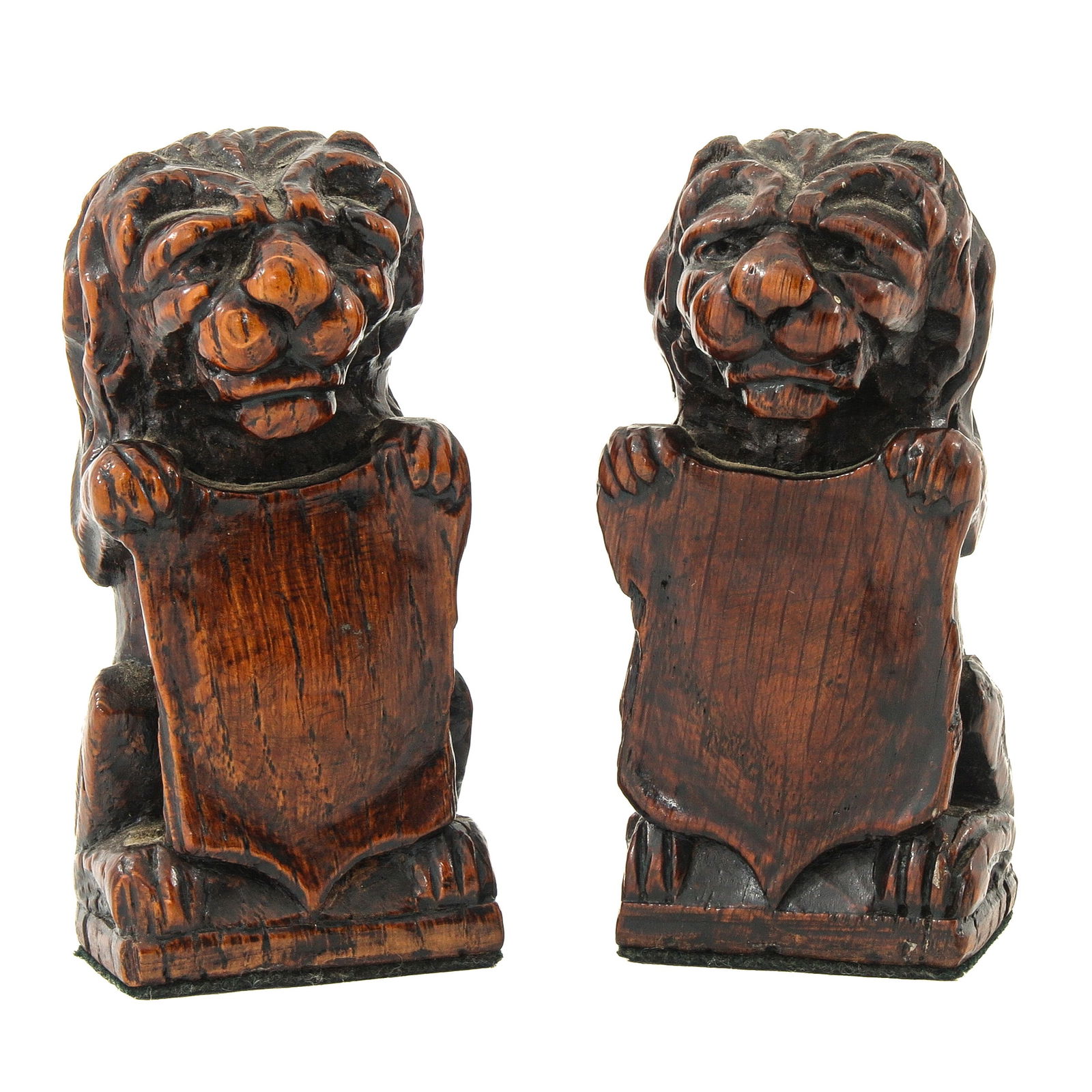 A Pair of 17th Century Lions: Carved wooden lions, 17th century, each with a shield, height 10 cm.