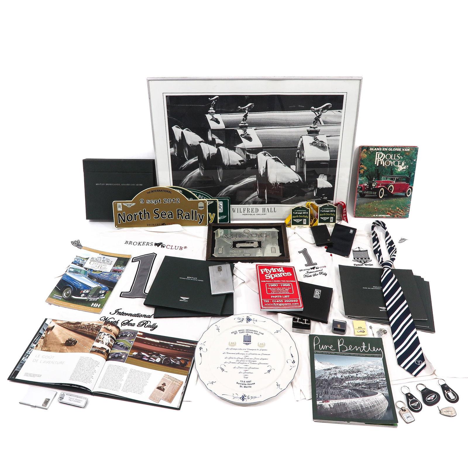 A Rare Collection of Rolls Royce and Bentley Memorabilia: Rolls Royce and Bentley memorabilia, including a 1997 Rolls Royce Jubilee Annual Rally plate by Villeroy & Boch, and a framed Wilfred Hall Rolls Royce Goodwood showroom poster.