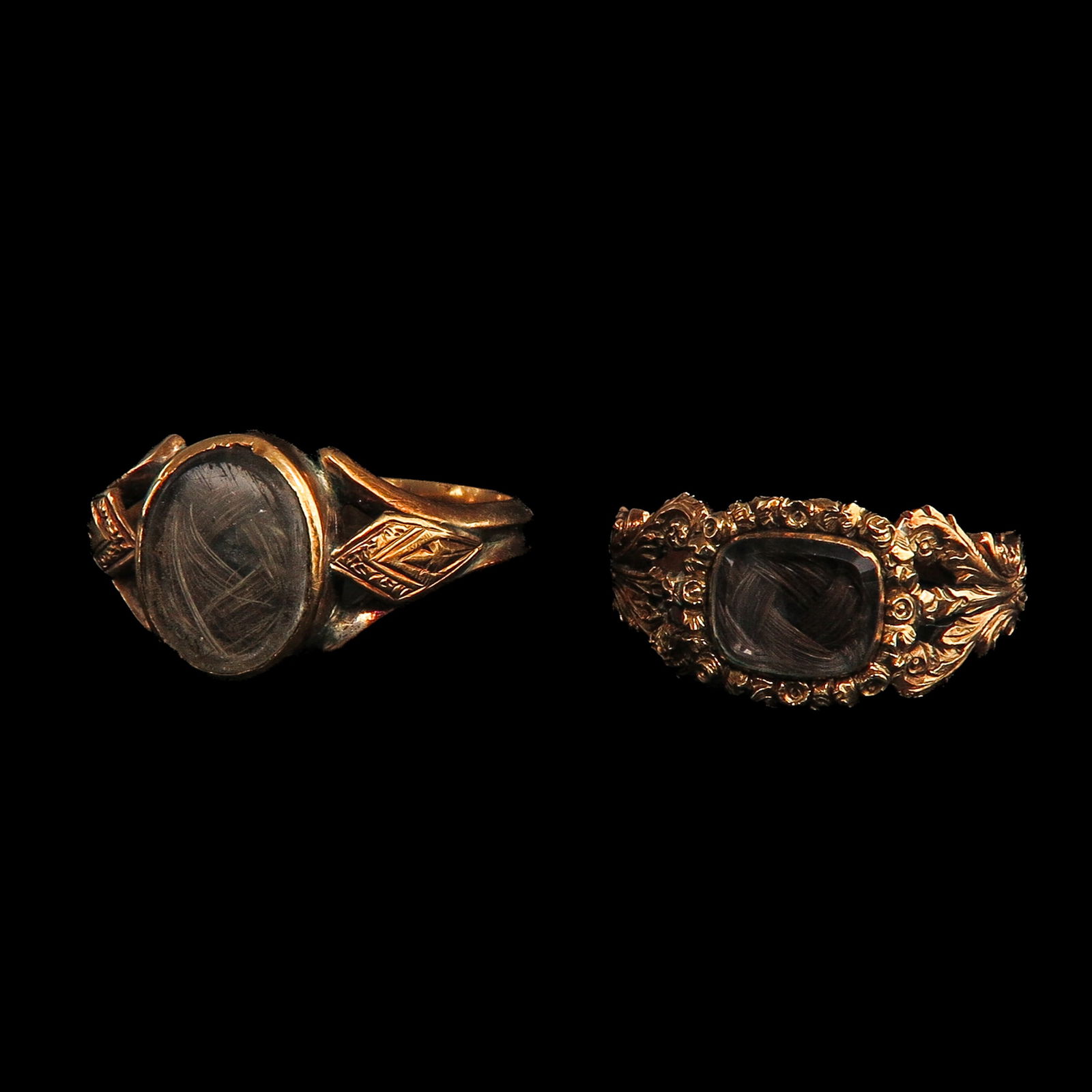 A Lot of 2 19th Century Mourning Rings: Consisting of 2 mourning rings with hair work, 19th century, largest ring size 18