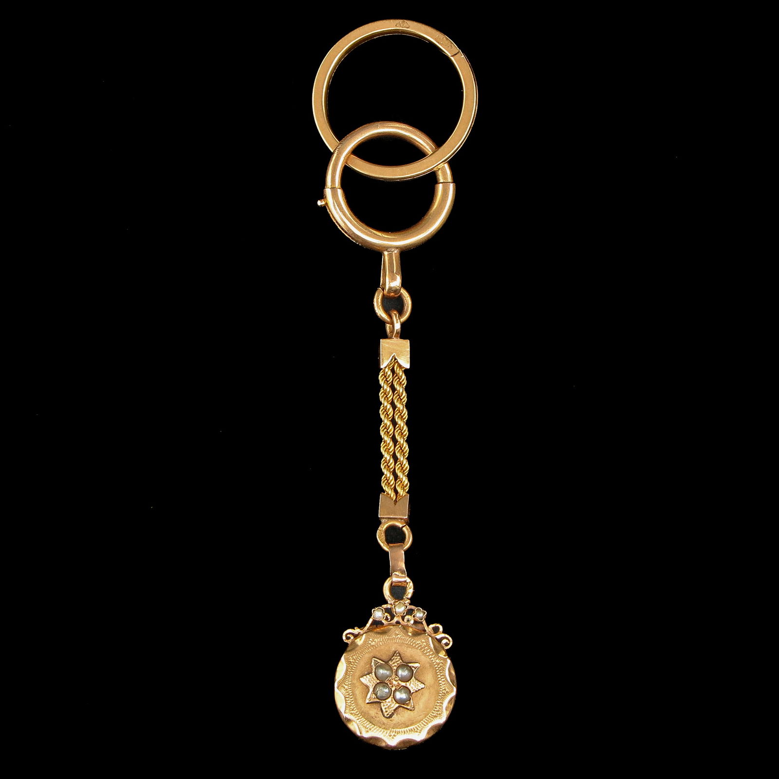 A Pocket Watch Chain: Gold, with a photo locket set with pearls, length 88 mm.