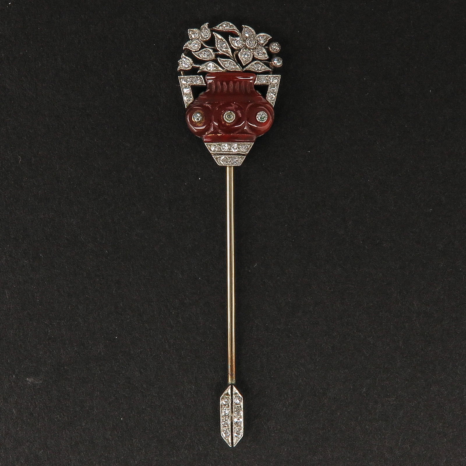 A Chabotpin: Art Deco period, set with diamonds and orange jade, ca. 1925, length 65 mm.