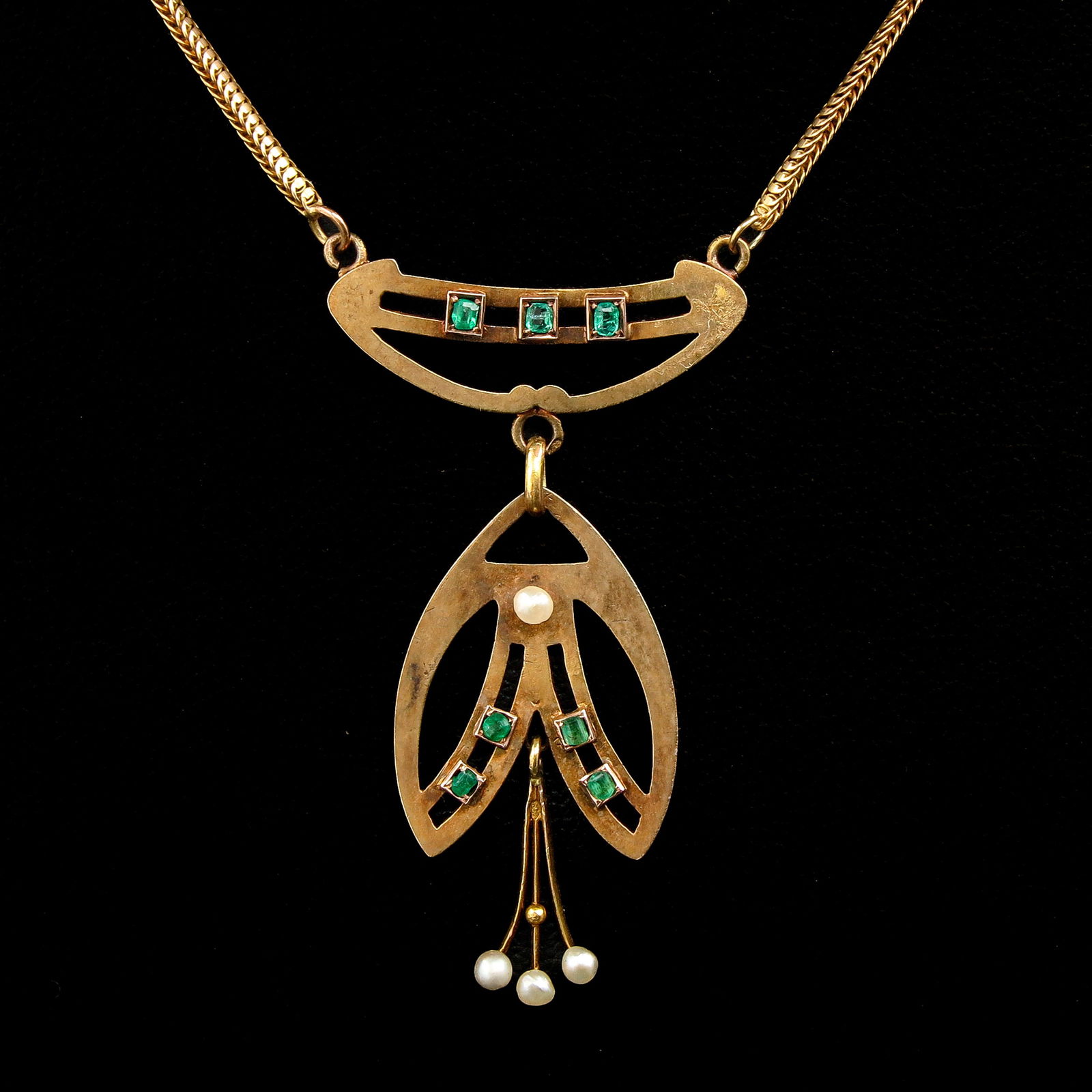 A 14KG Art Nouveau Necklace: 14-karat gold, Art Nouveau period, set with square green stones and seed pearls, pendant length 43 mm.