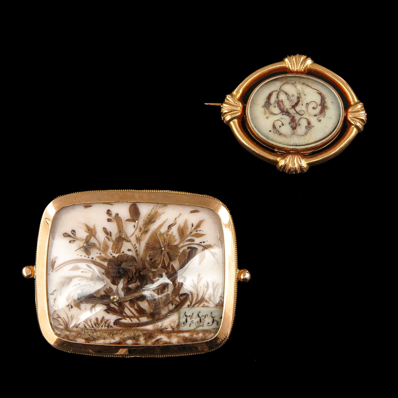 A Lot of 2 19th Century Mourning Brooches: Consisting of two 19th-century gold mourning brooches with hair, largest 31 x 39 mm.