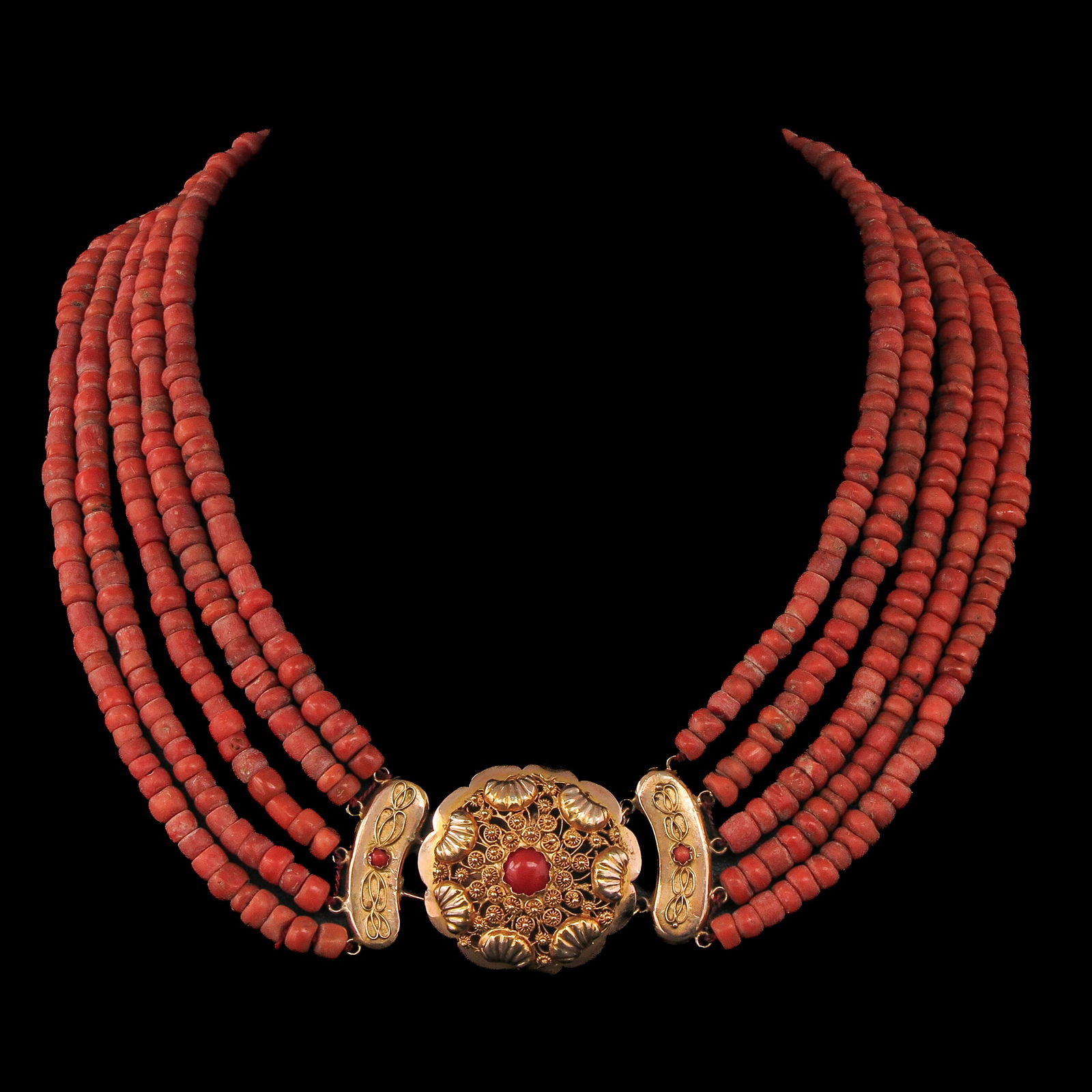 A 5 Strand Red Coral Necklace: With 5 rows of red coral, 19th century, Walcheren, 14-karat gold clasp set with precious coral, diameter 34 mm, bead diameter 6-7 mm, weight 118 grams.