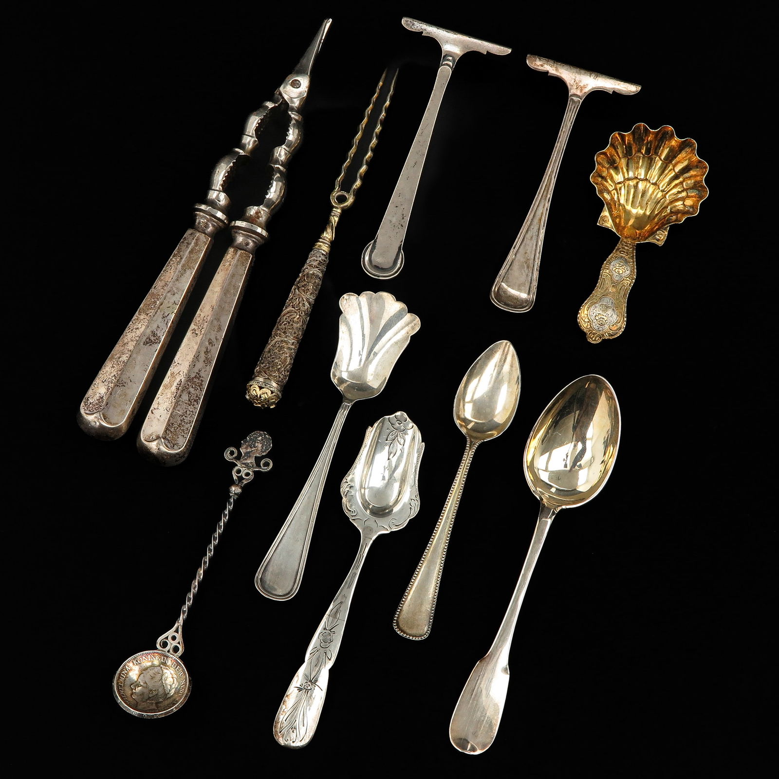 A Group of Cutlery: Including a fork, 18th/19th century, handle decorated with filigree, length 147 mm.
