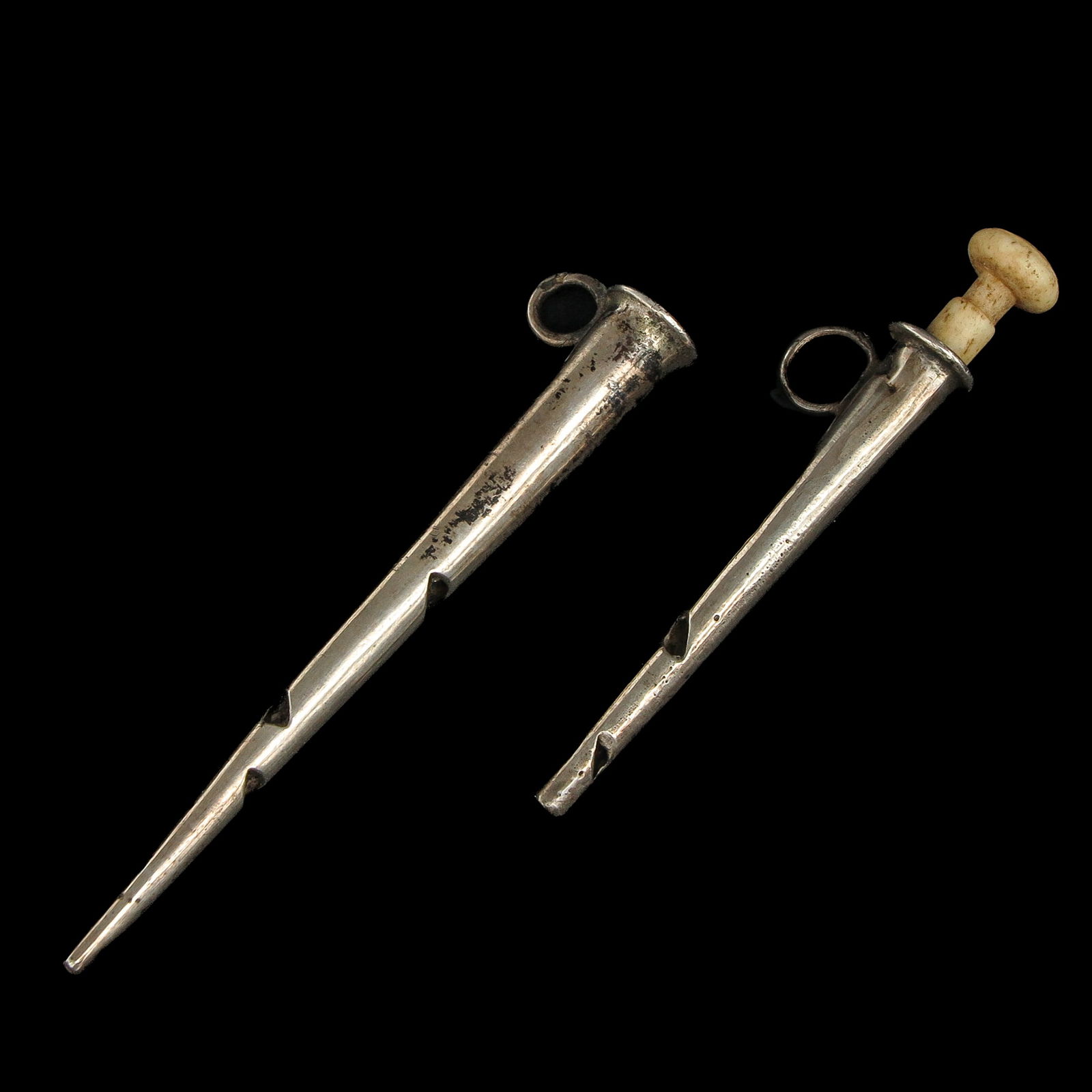 A Lot of 2 Egg Piercers: Consisting of two egg piercers, 19th century, reversed silver, length 5 cm.