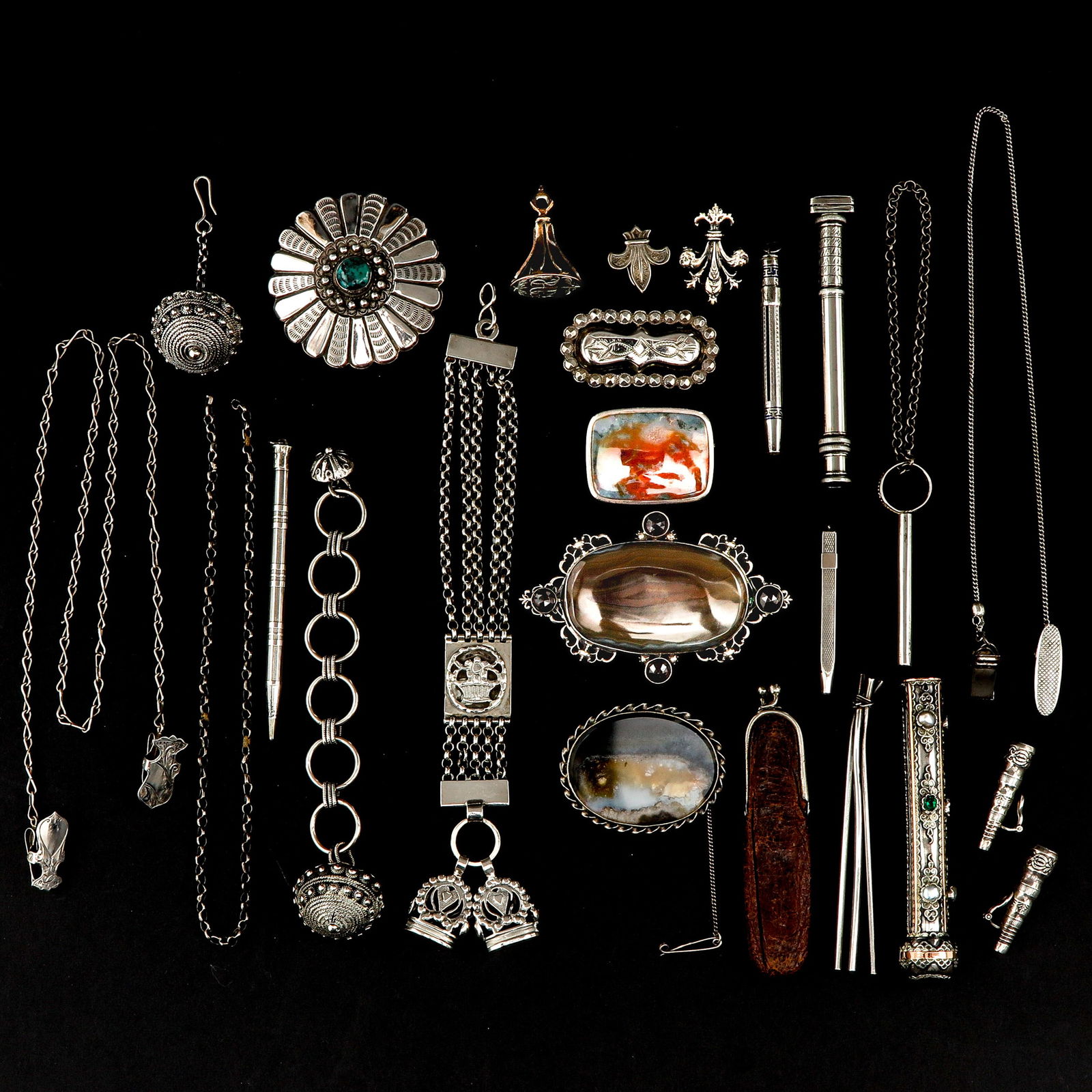 A Diverse Collection of Items: Various objects, including a silver watch chain
