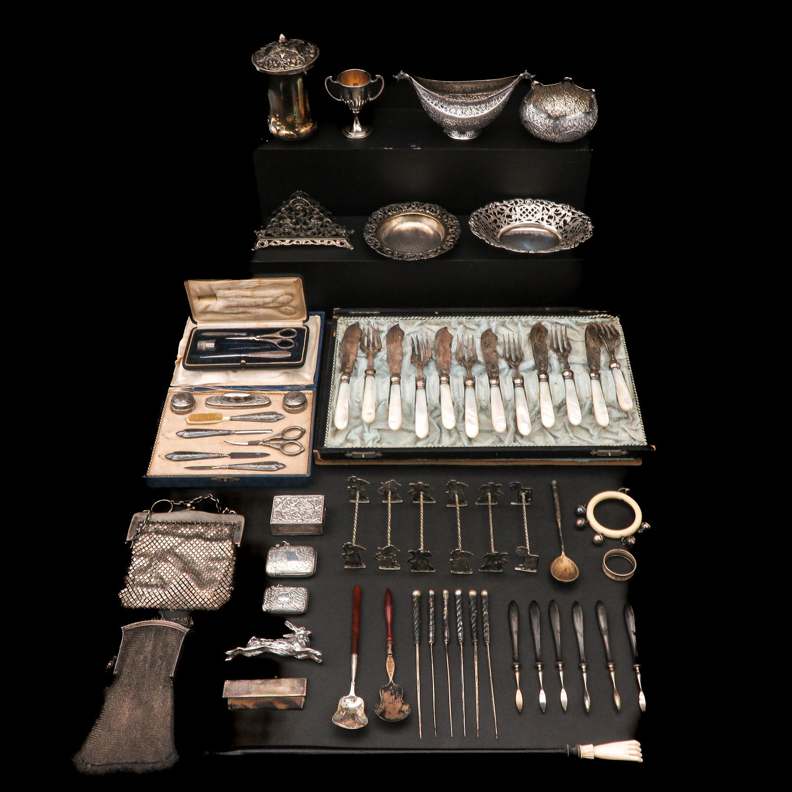 A Diverse Collection of Items: Various silver and silver-plated items, including a cassette with forks and mother-of-pearl handles.