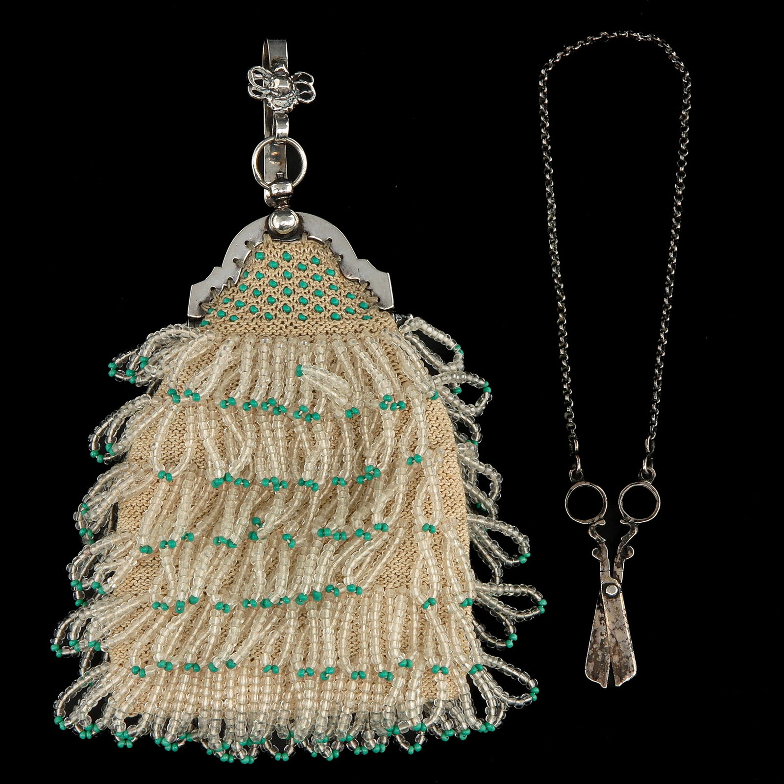 A Miniature Purse: Silver with miniature scissors on a chain, length 15 cm.