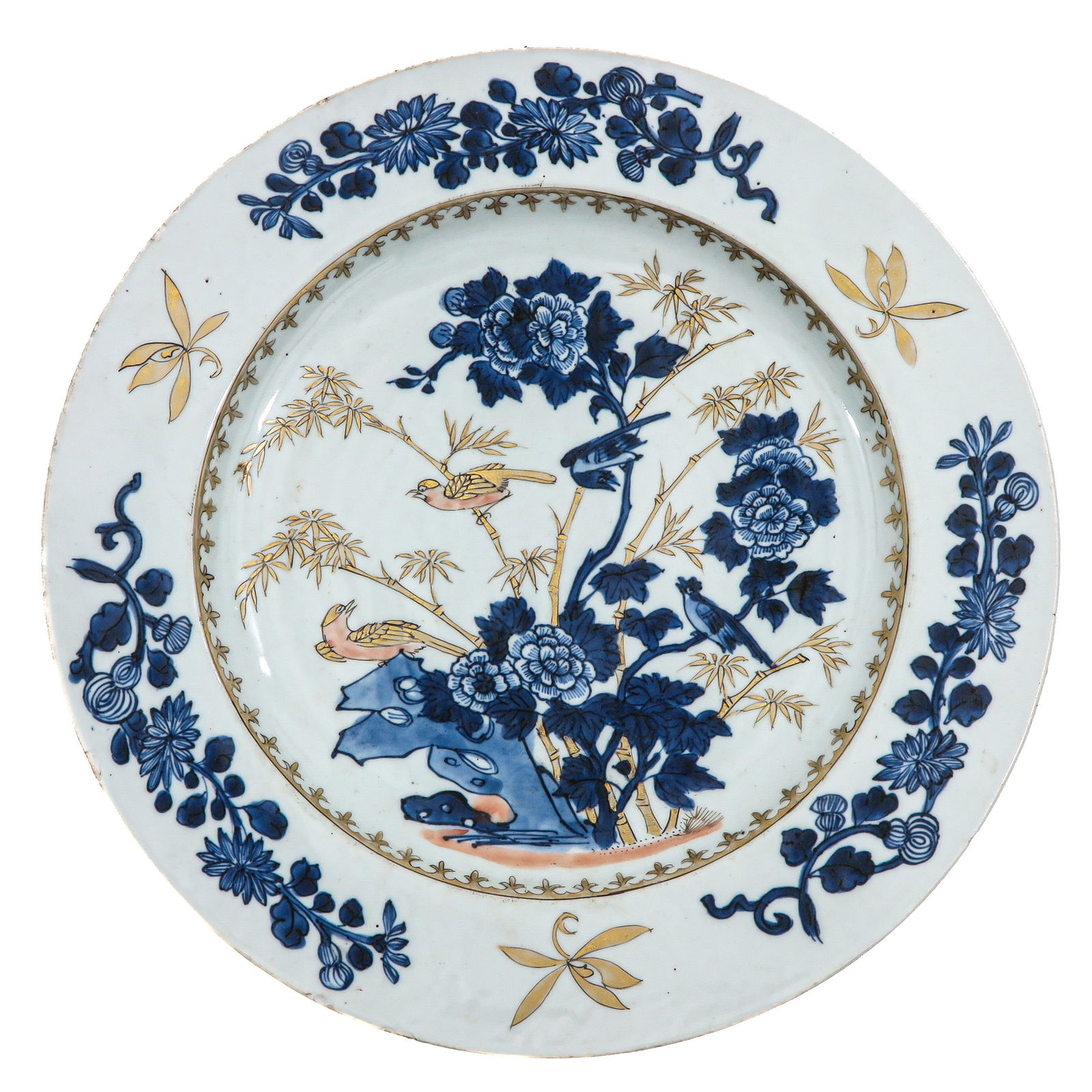A Blue and Gilt Decor Charger: Depicting a garden scene with peonies and bamboo within a floral border, 18th Century, 34 cm. in diameter, chip.