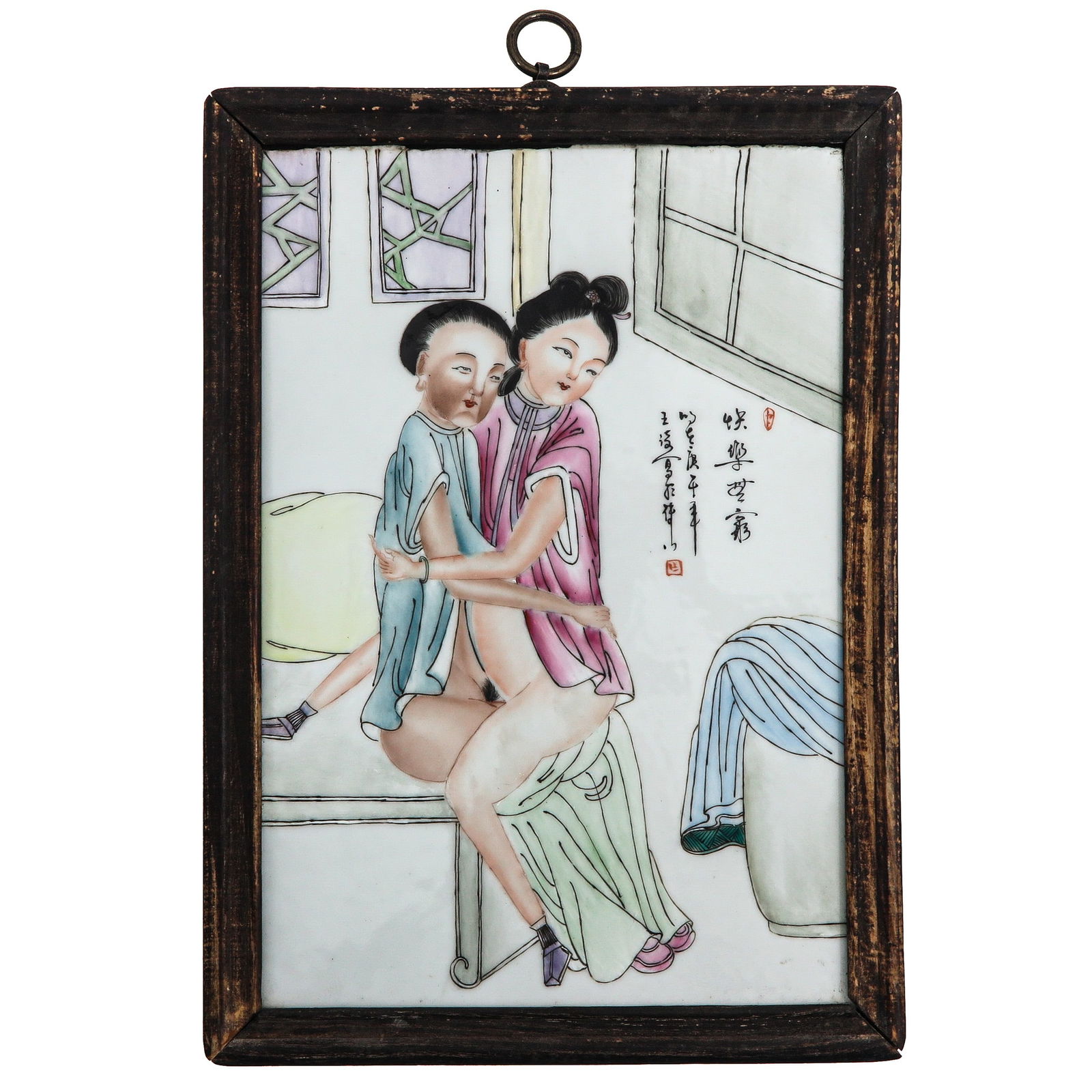 A Framed Chinese Plaque: Painted in Famille Rose enamels with an interior scene of two embracing figures, with calligraphy and red seal marks, 23 x 34 cm.