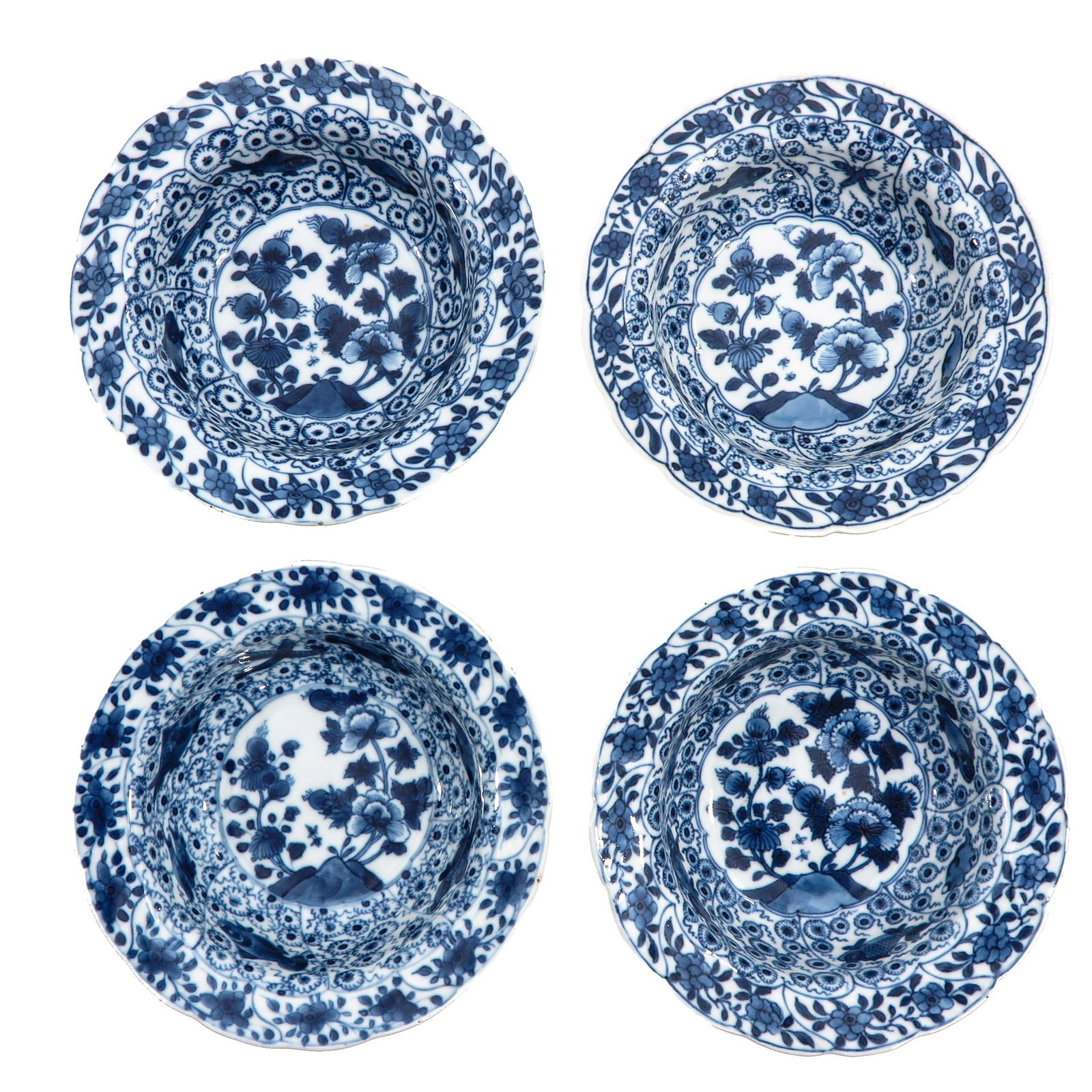 A Group of 4 Blue and White Plates: Decorated with floral medallions and scrolling foliage, 18th Century, 16 cm. in diameter, chip.
