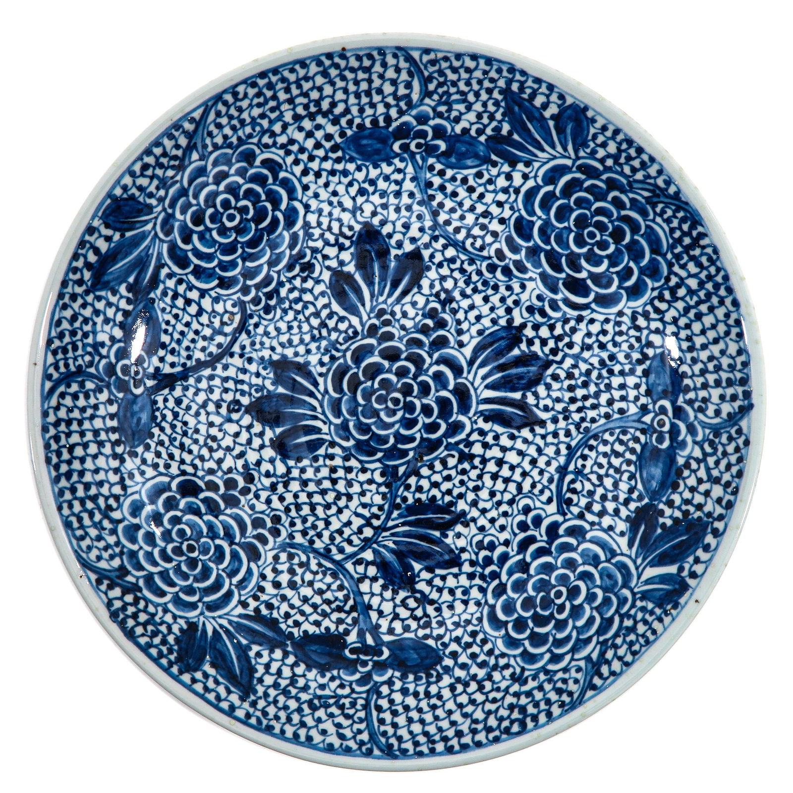 A Blue and White Charger: Densely decorated with scrolling foliage and chrysanthemum in underglaze blue, 18th Century, 35 cm. in diameter.
