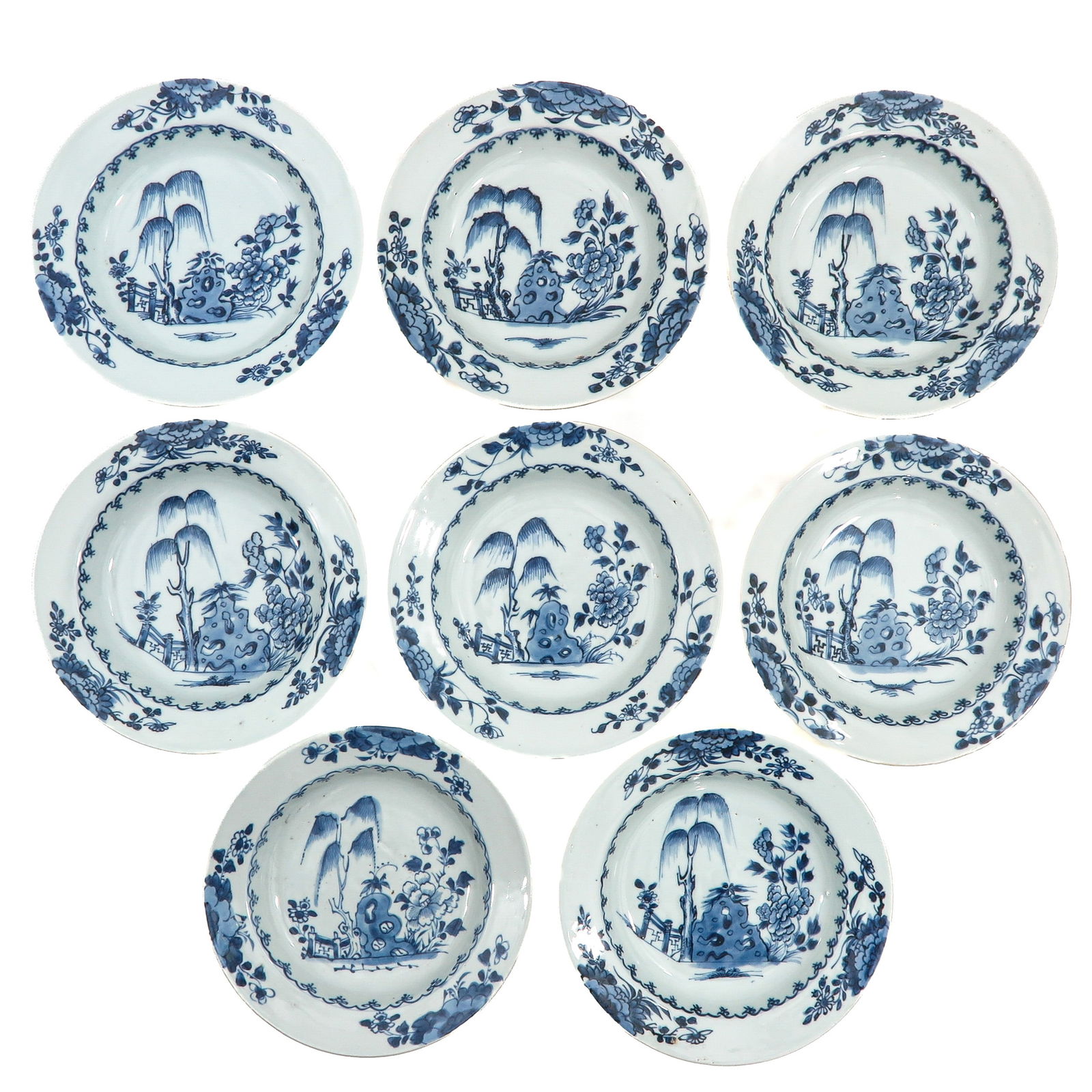 A Series of 8 Blue and White Plates: Decorated with a garden landscape featuring rockwork,, flowering plants an a willow tree, 18th Century, 23 cm. in diameter, chip. Collection of Nanking Cargo