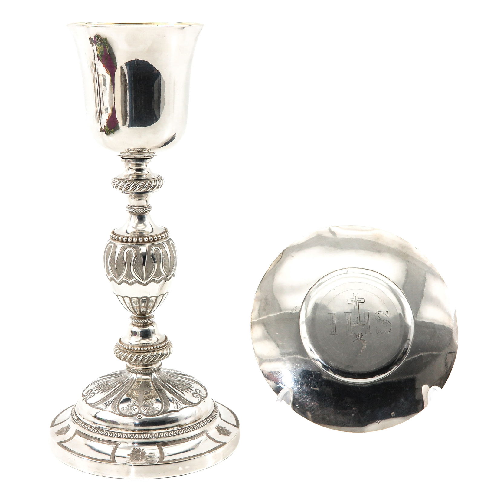 A Chalice: With paten and gilded silver cuppa, Alexandre Thierry, Paris, ca. 1850. The paten belongs to the chalice and bears identical hallmarks. Height 28 cm.