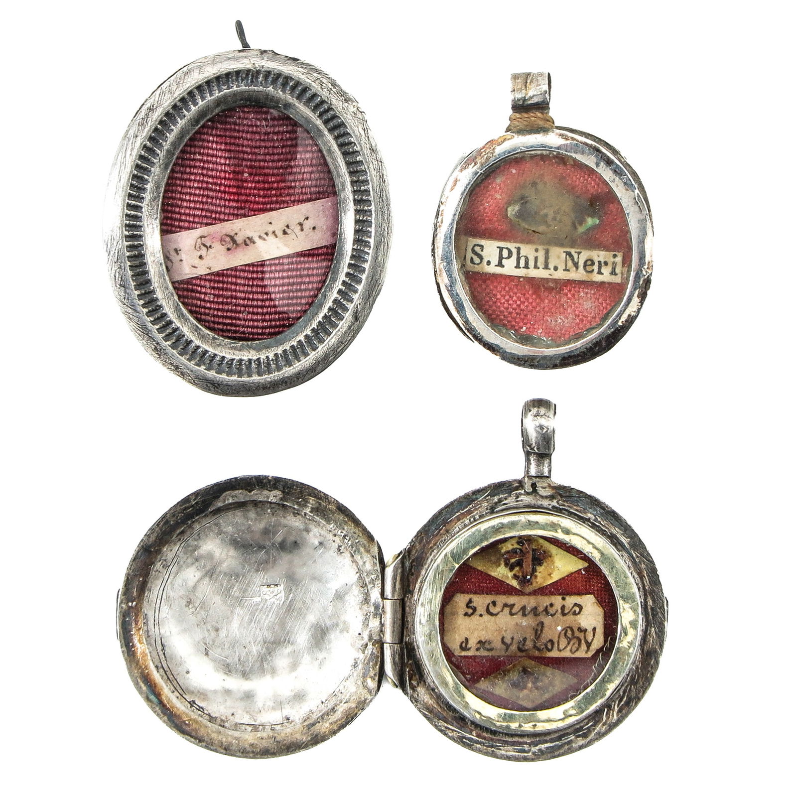A Group of 3 Relics: Consisting of 3 relics, including Saint Philip Neri (patron of Rome, youth, and joy), diameter cm. You are purchasing the theca; the relics are a gift. Largest length 2.5 cm.