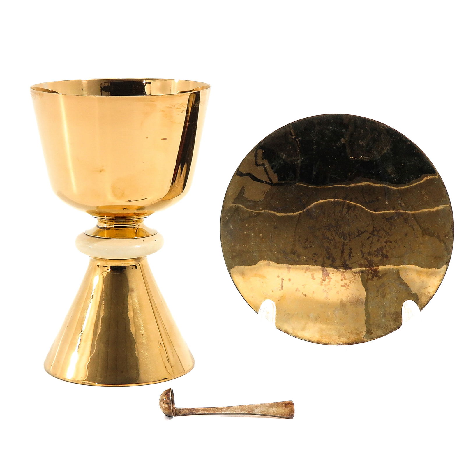 A Chalice: With paten and spoon, gilded 1st century carved silver, with case, height 16 cm.