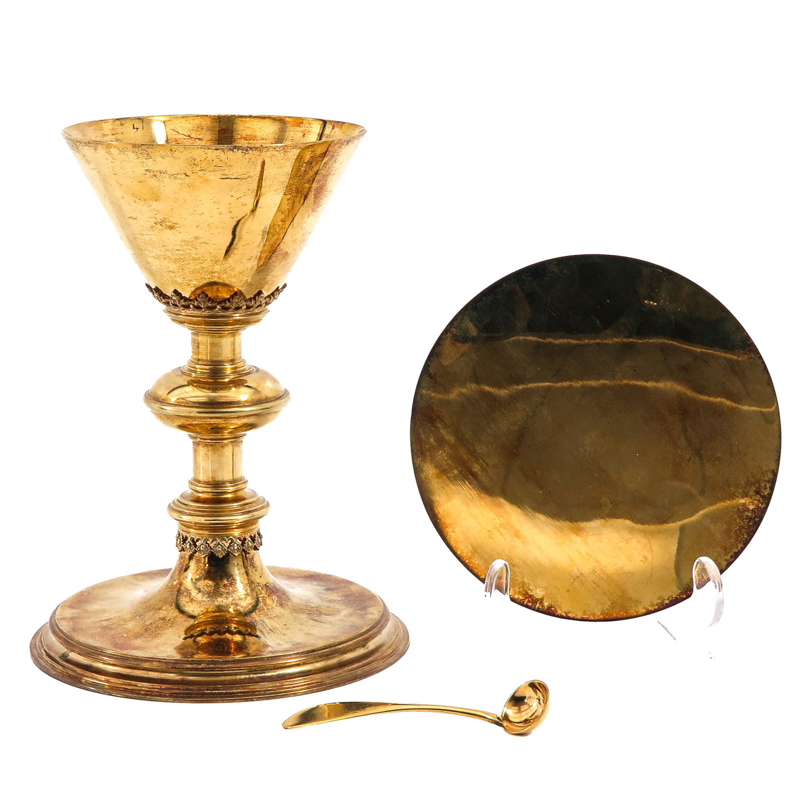 A Chalice: With paten and spoon, Neo-Gothic style. Cuppa is gilded silver, with case, height 20 cm.