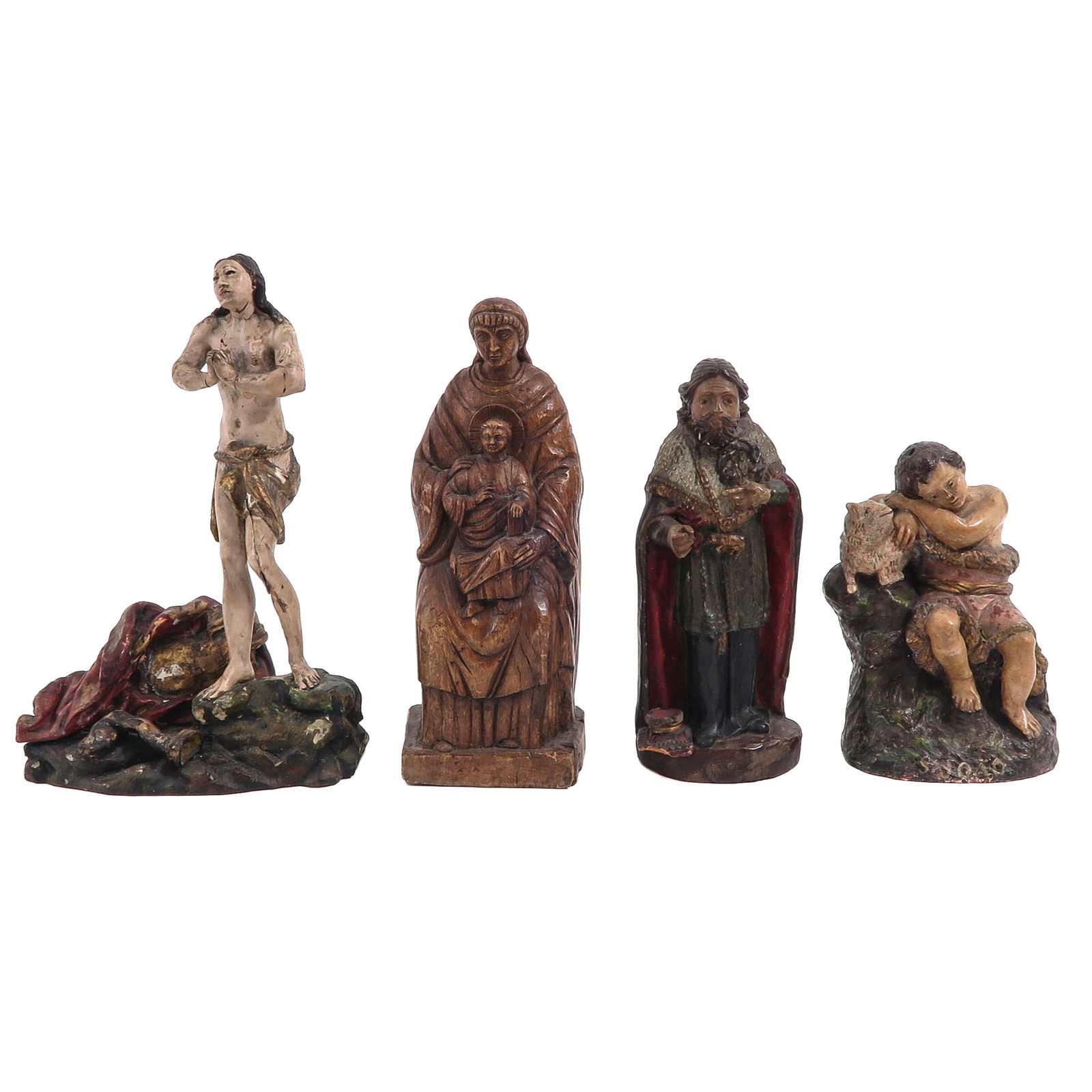 A Group of 4 Sculptures: Consisting of four polychrome wooden holy statues, 18th/19th century, including Saint Sebastian, height 30 cm.