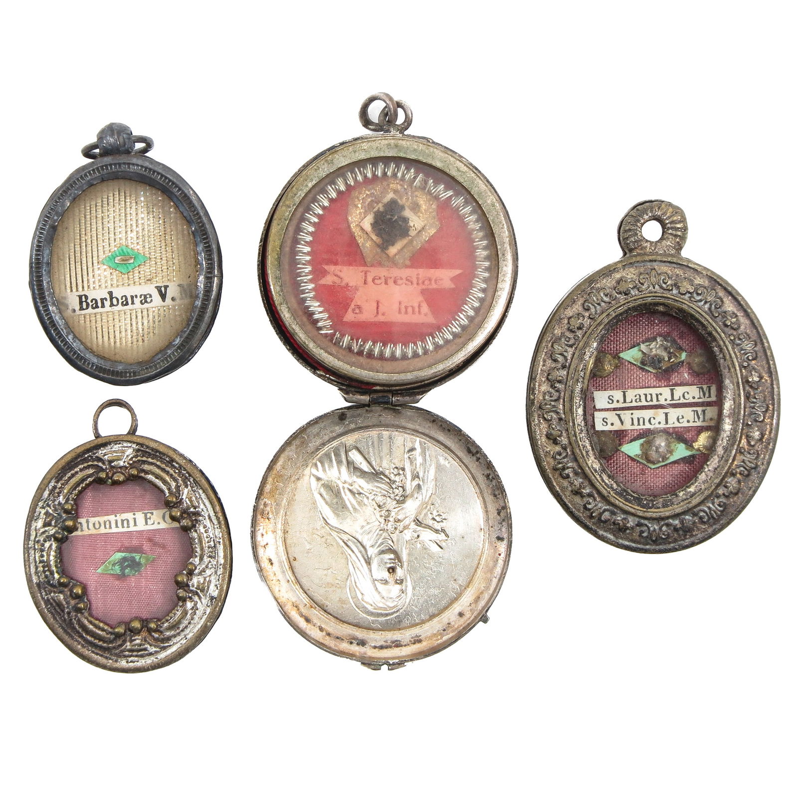 A Group of 4 Reliquary Pendants: Consisting of 4 reliquary pendants, containing relics of Saint Barbara (patron of the missions) and Lawrence (patron of cooks), the largest 4.5 cm. You are purchasing the theca; the relics are a gift.