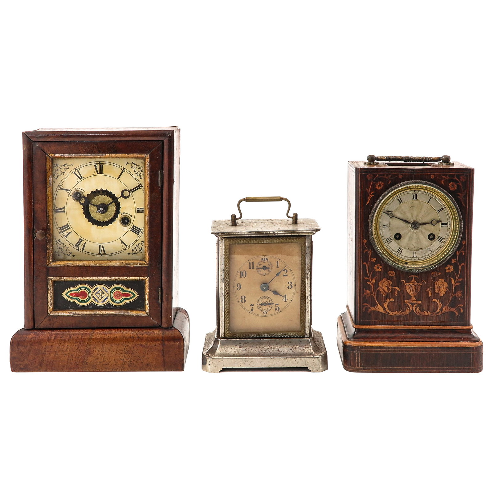 A Group of Clocks: consisting of an American table clock with alarm and paper label on the back, a wooden table clock with inlaid work and silver-plated dial and a metal alarm, height 25 cm