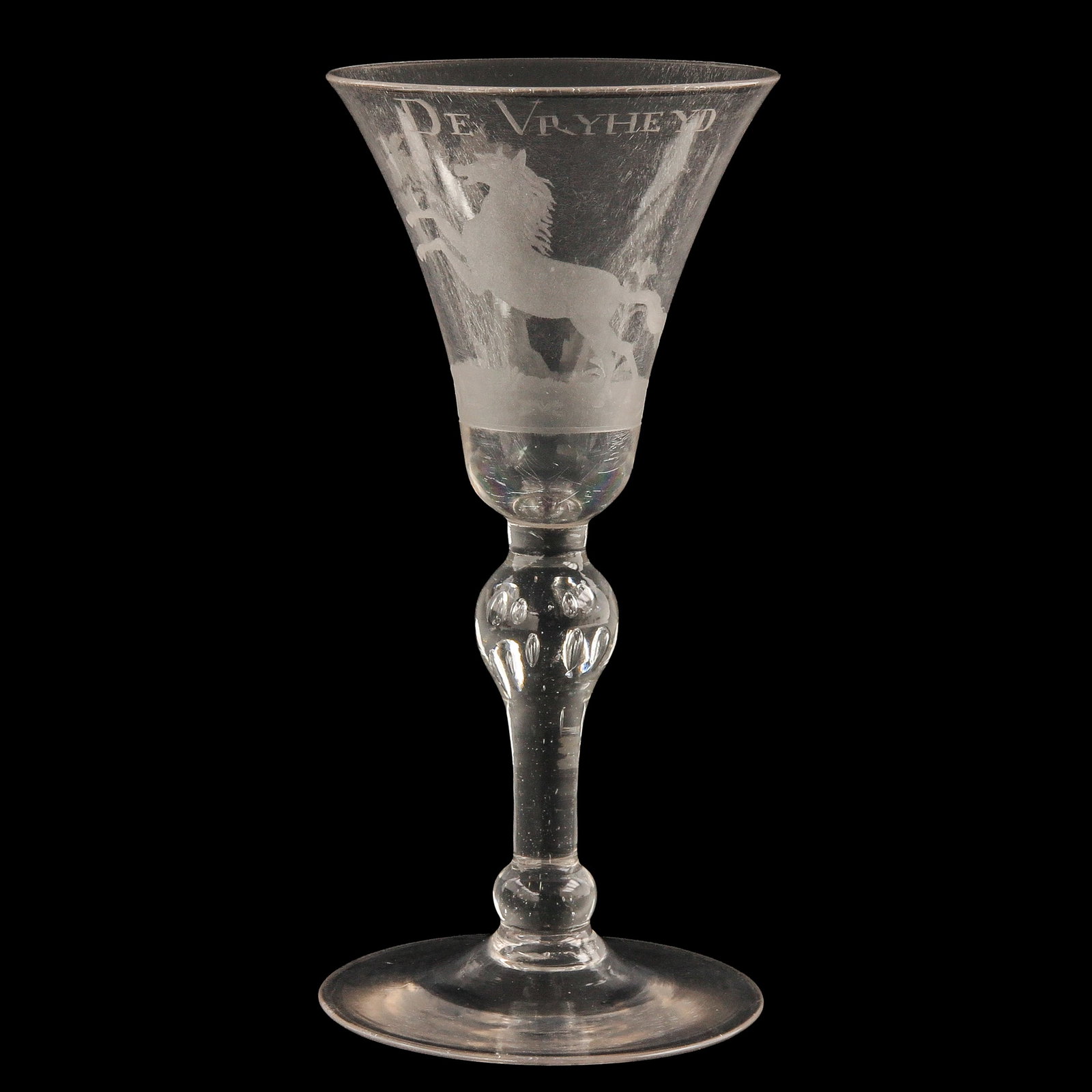 An 18th Century Engraved Glass: England, 18th century, engraved with a horse and the text “De Vryheyd” height 19 cm