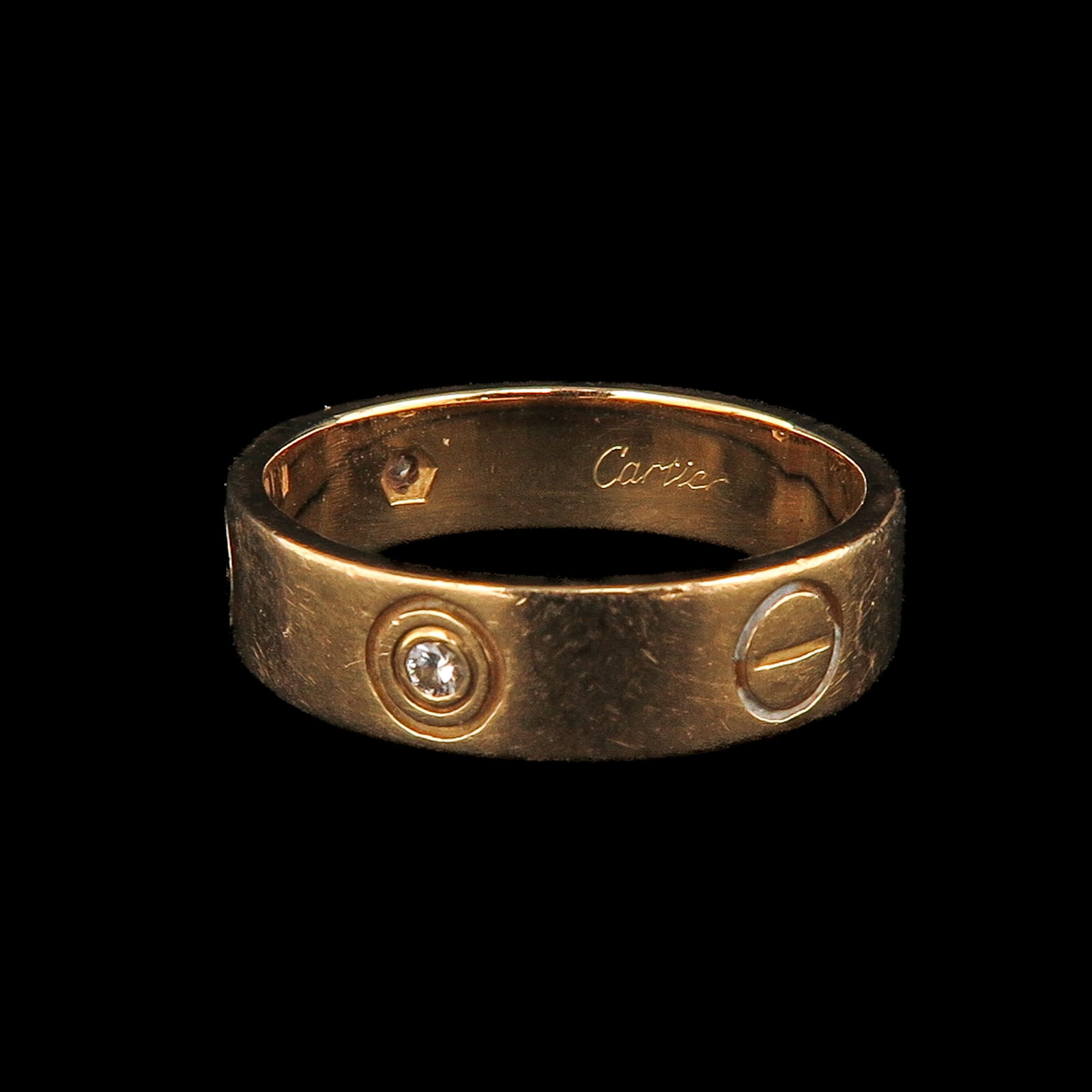 An 18KG Cartier Love Ring: 18 Krt. gold, Cartier love ring, designed by Aldo Cipullo, set with 3 diamonds, ring size 18.5, with box and papers, engraved with number 750-550723181
