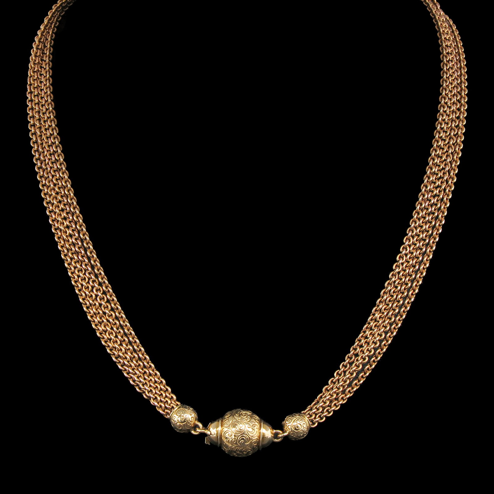 A Necklace: with 4 rows of fine links, fitted with a ball-shaped clasp, 18 Krt. gold, length 41 cm
