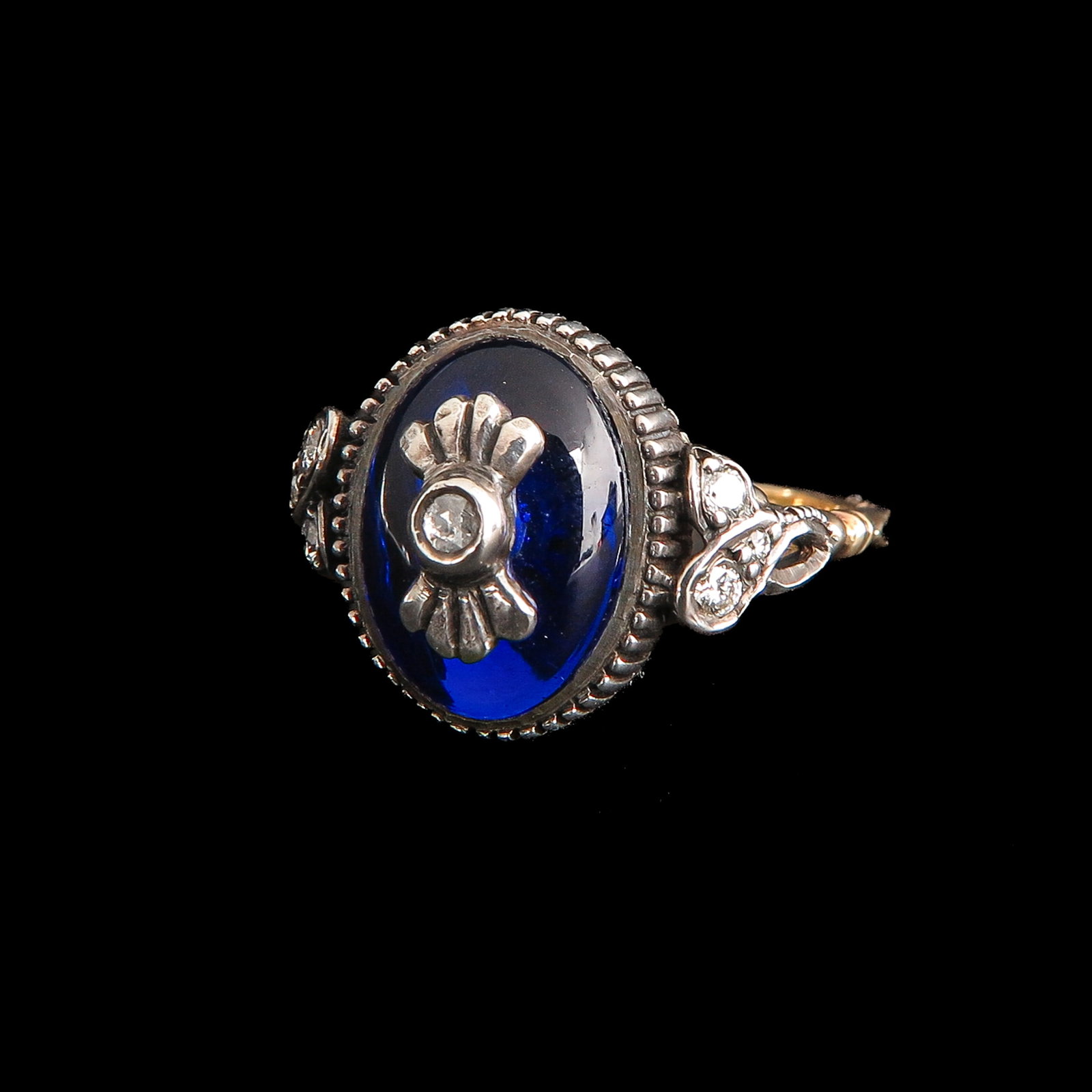 A Ladies Diamond Ring: gold on silver, with Bohemian blue glass and diamonds, ring size 17.5