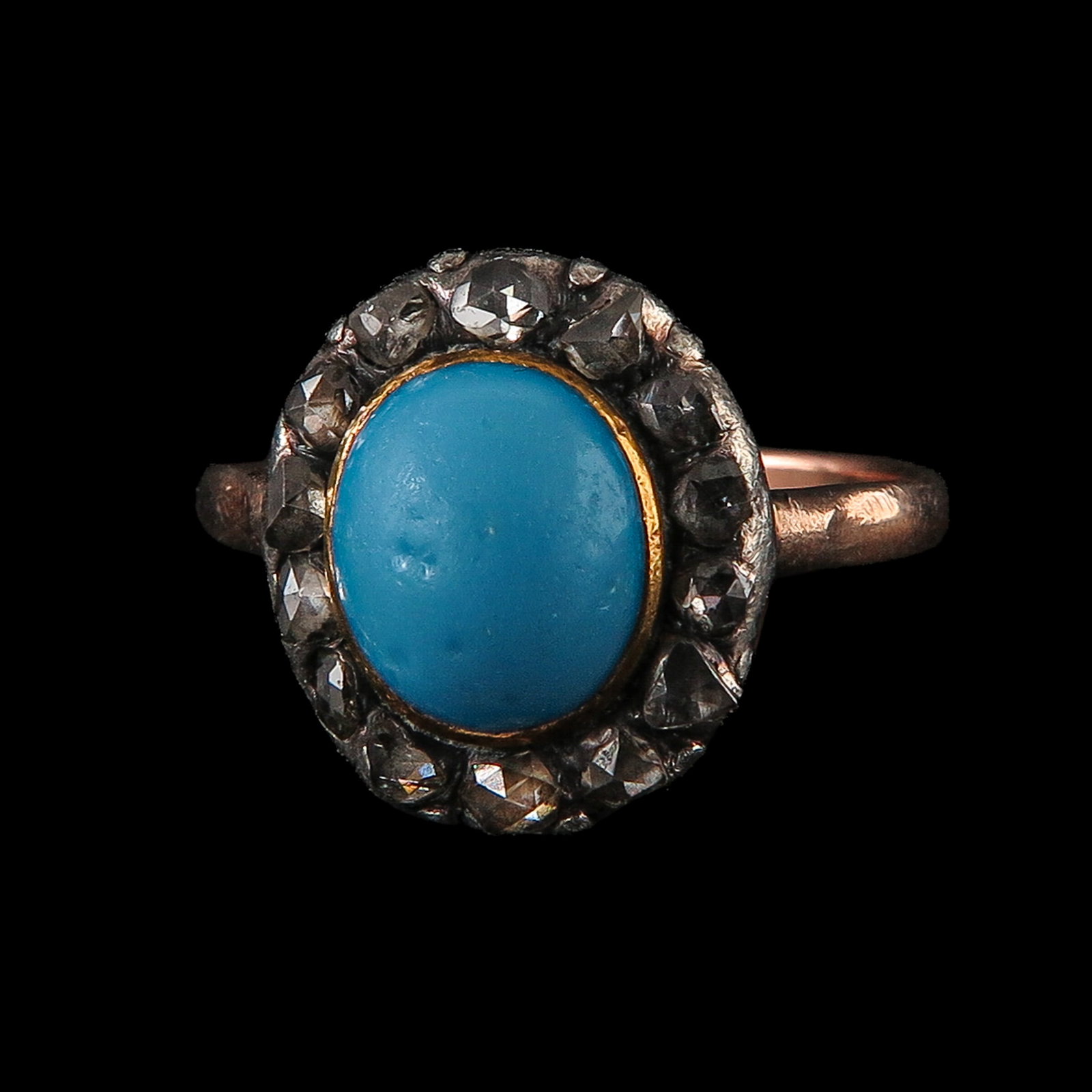 A Ladies 14KG Turquoise and Diamond Ring: 14 Krt. gold with silver setting, set with a cabochon cut turquoise, surrounded by rose-cut diamonds, ring size 18