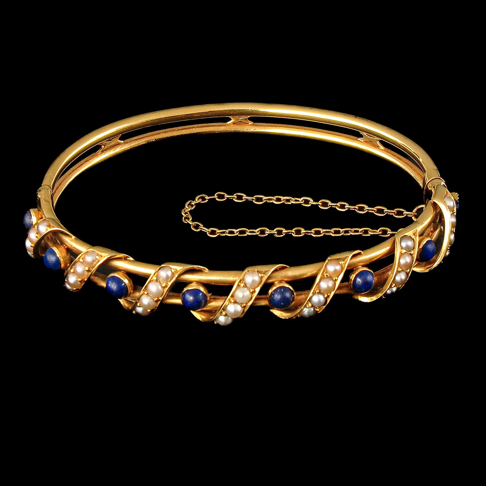 A 14KG Lapis Lazuli and Pearl Bracelet: 14 Krt. gold, set with 8 lapis lazuli and oriental pearls, inner diameter 6.5 cm