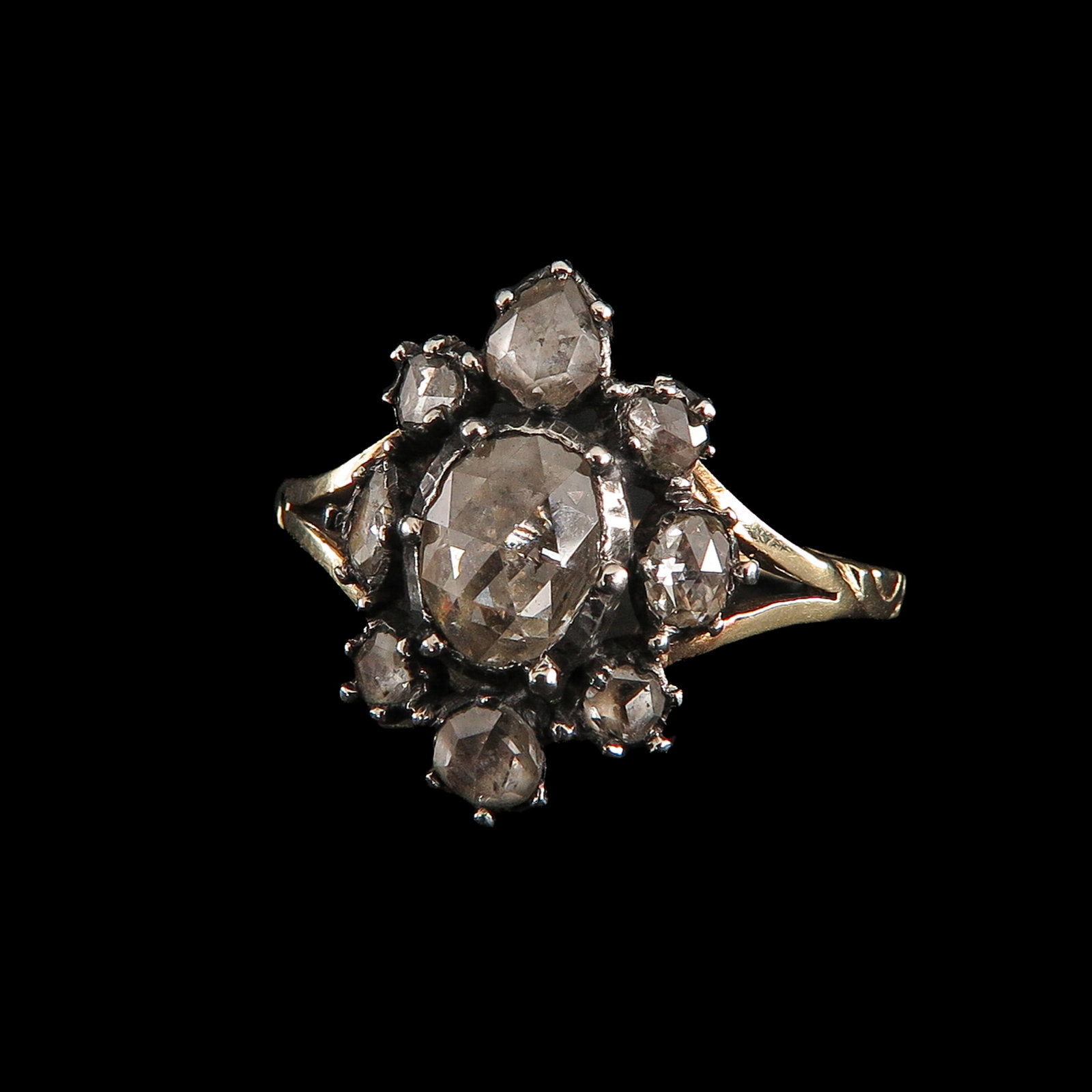 A Ladies Diamond Ring: gold, with silver setting, set with 9 rose-cut diamonds ring size 18.5