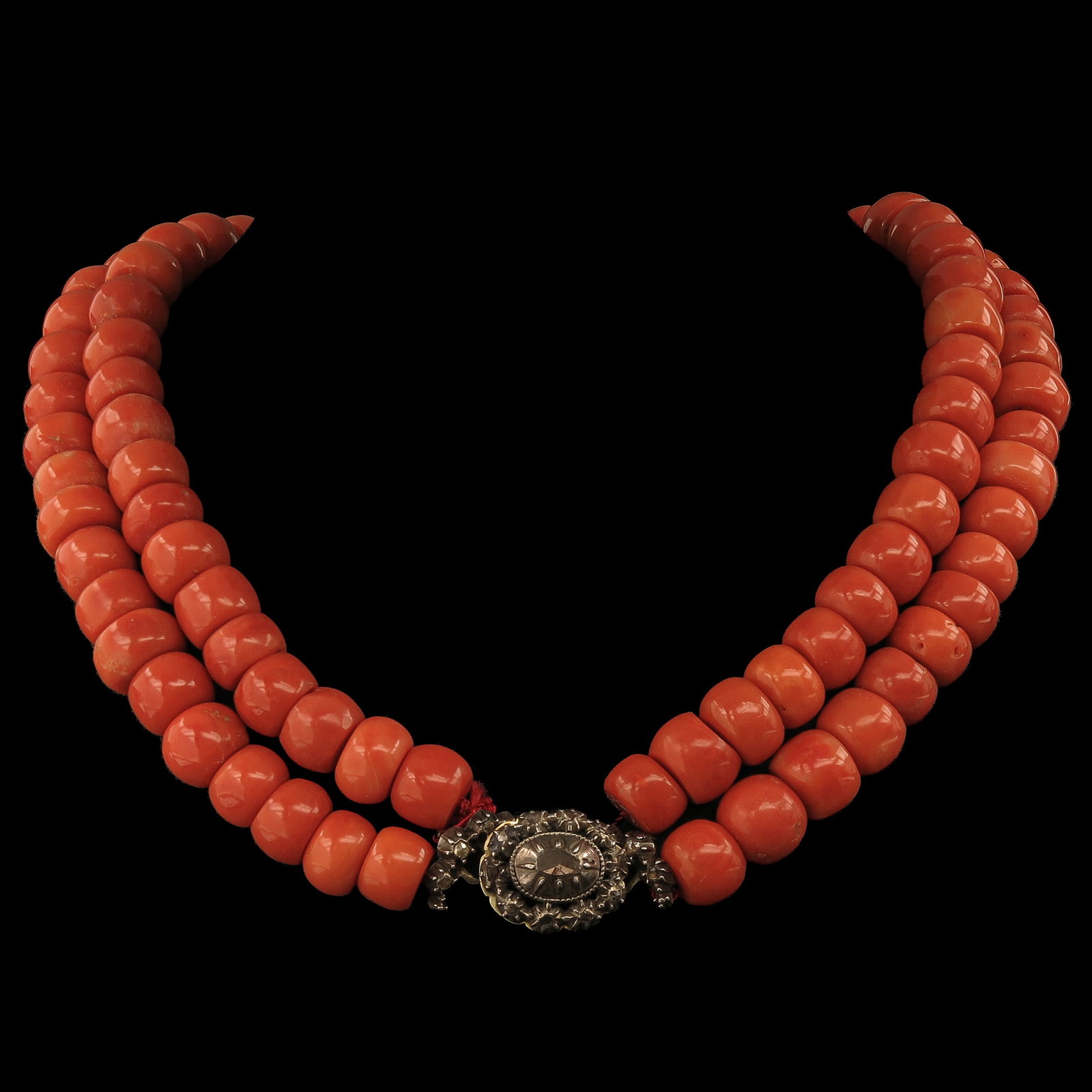 A Red Coral Necklace: with 2 rows of red coral, bead diameter 11 - 12 mm, clasp set with diamonds, weight 205 grams