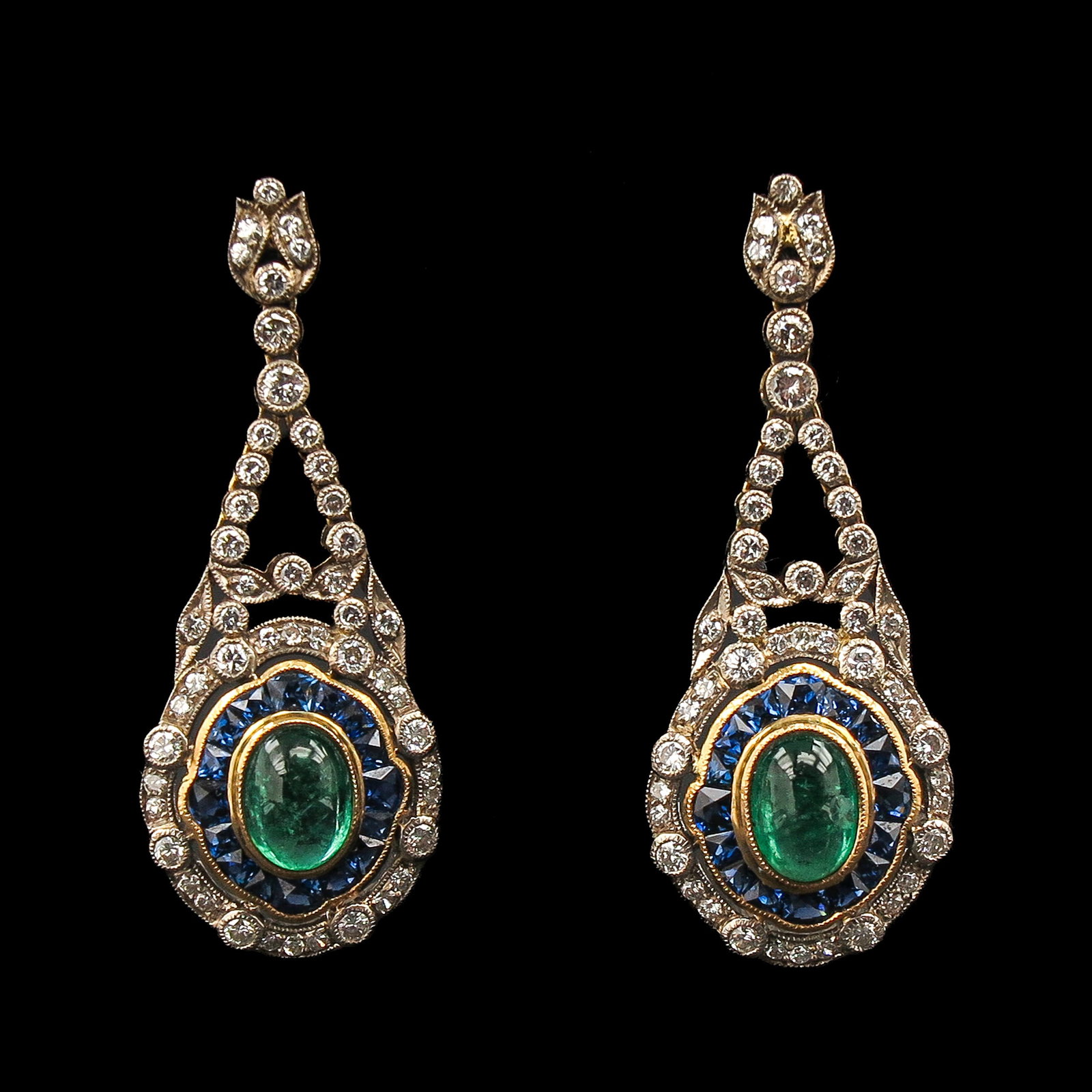 A Pair of Emerald and Diamond Earrings: 14 Krt. gold, antique, oval-shaped ends with a central oval cabochon-cut emerald, including square-cut sapphires and small diamonds, all in millegriffe setting, length 42 mm