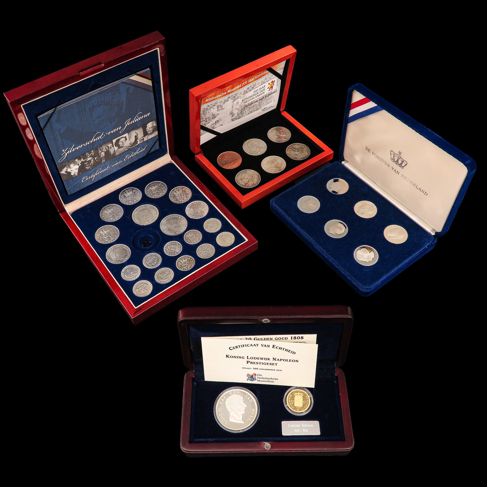 A Group of 4 Cassettes with Coins: consisting of 4 cassettes with coins, including silver