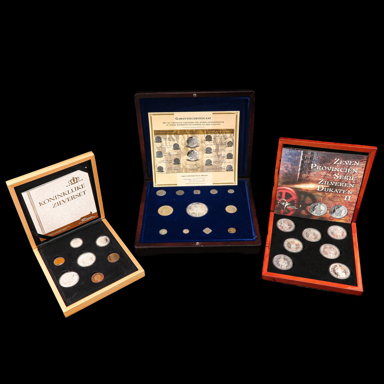 A Group of 3 Cassettes with Coins: consisting of 3 cassettes with coins, including silver