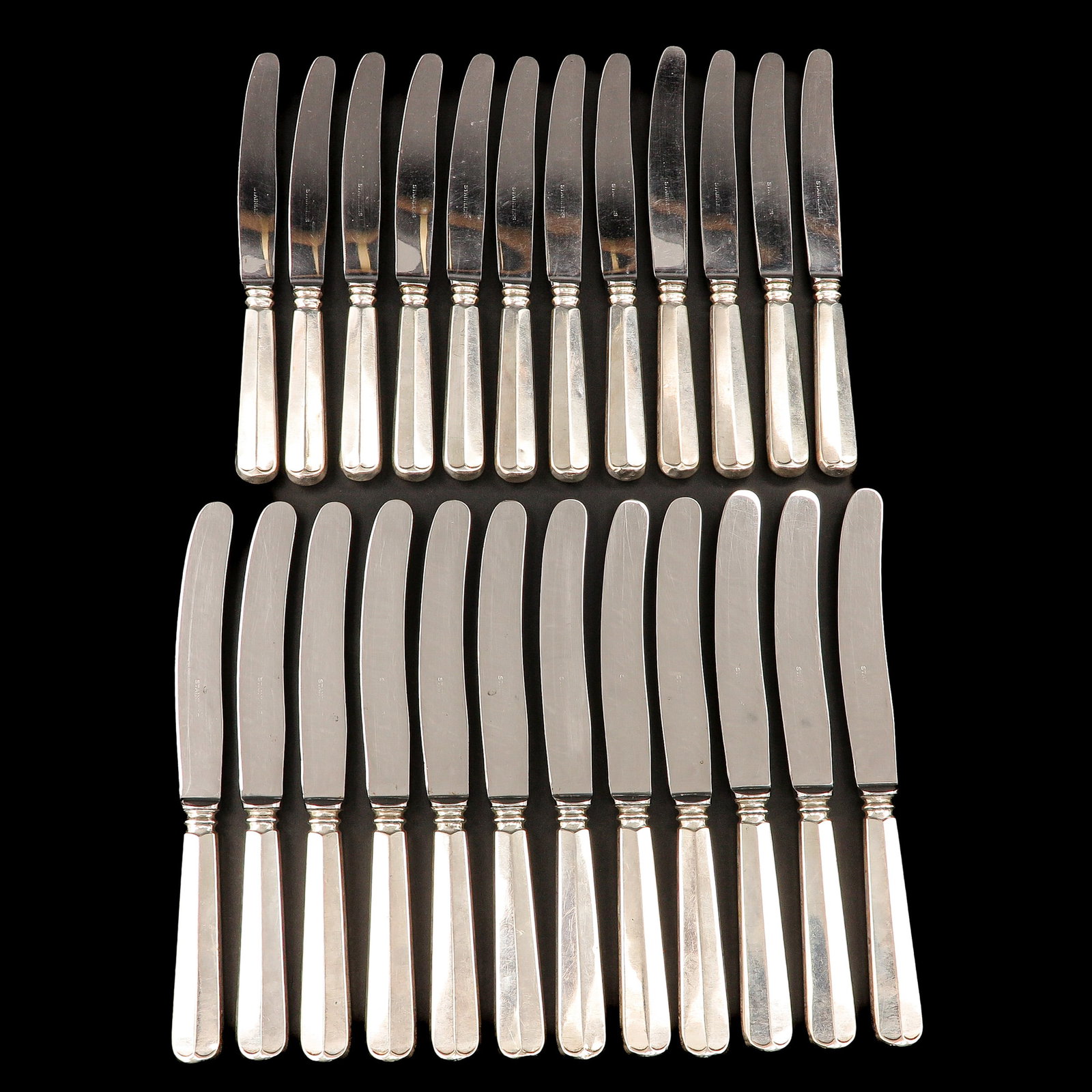 A Collection of Talbe Knives: of 24 table knives, with Dutch silver handles, longest 25 cm