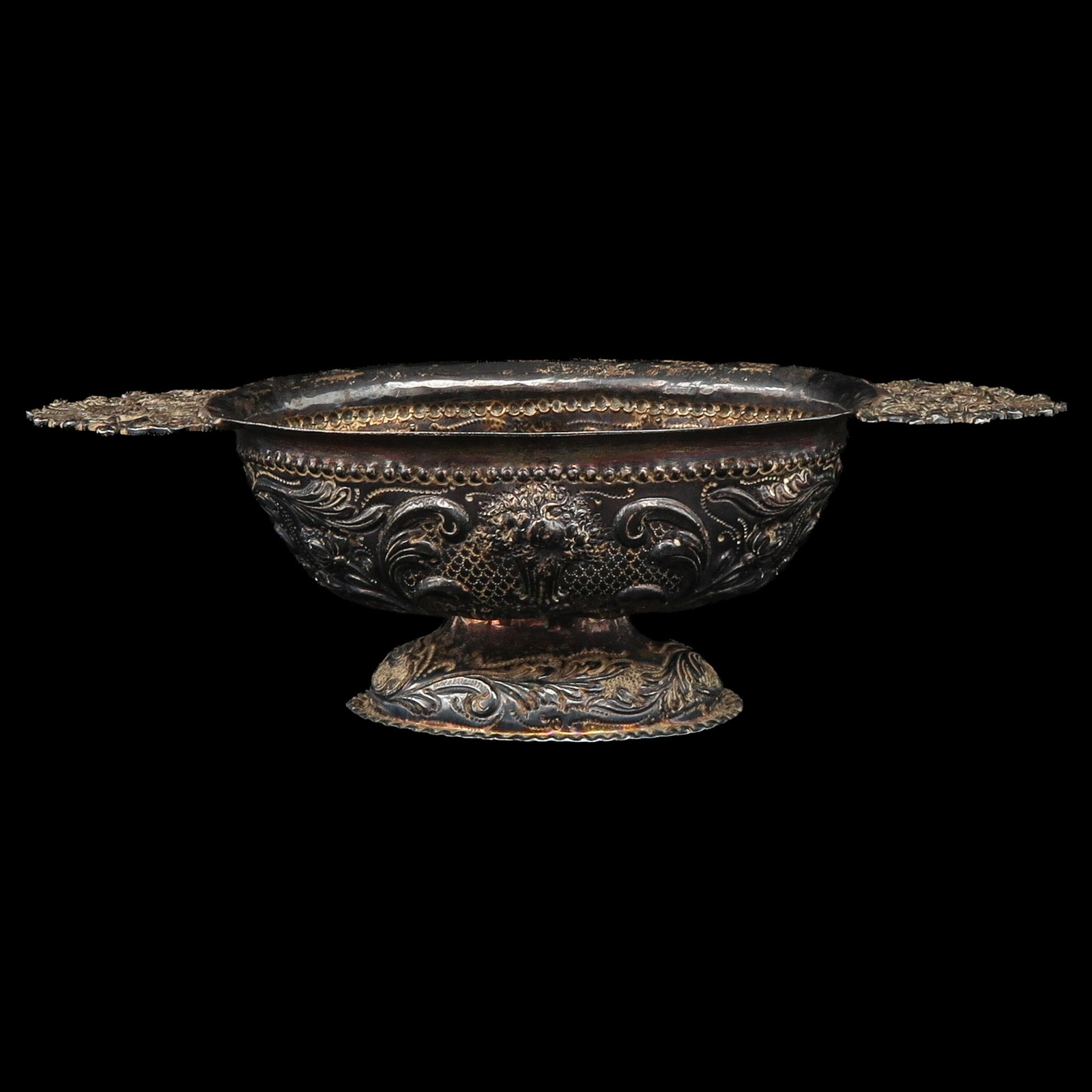 A Silver Brandy Wine Bowl: silver, richly decorated with chased scroll and floral motifs, length 25 cm