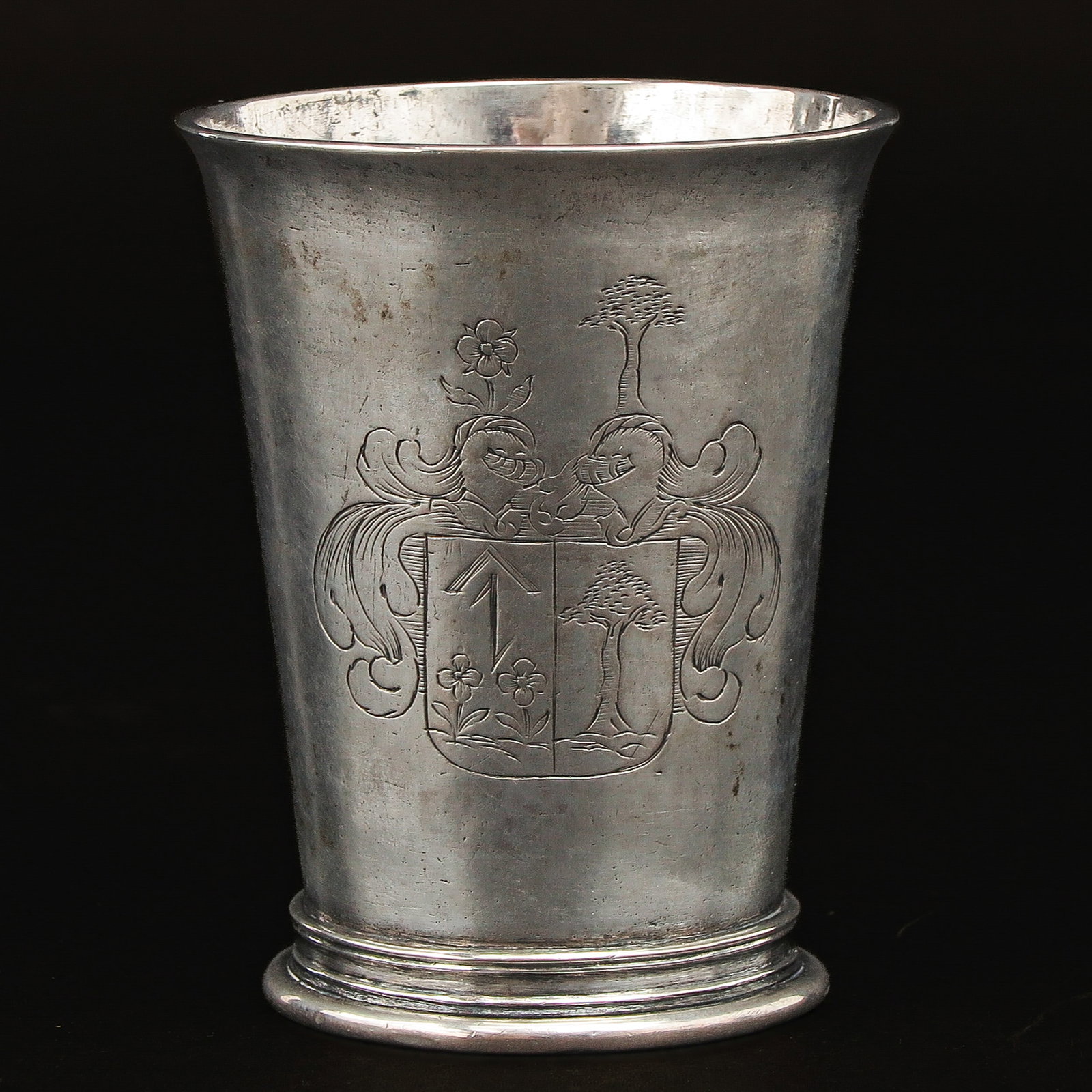 A Silver Cup: silver, with maker's mark of Jakobus Lutz, Cologne, 17th century, engraved with family coat of arms, height 8 cm