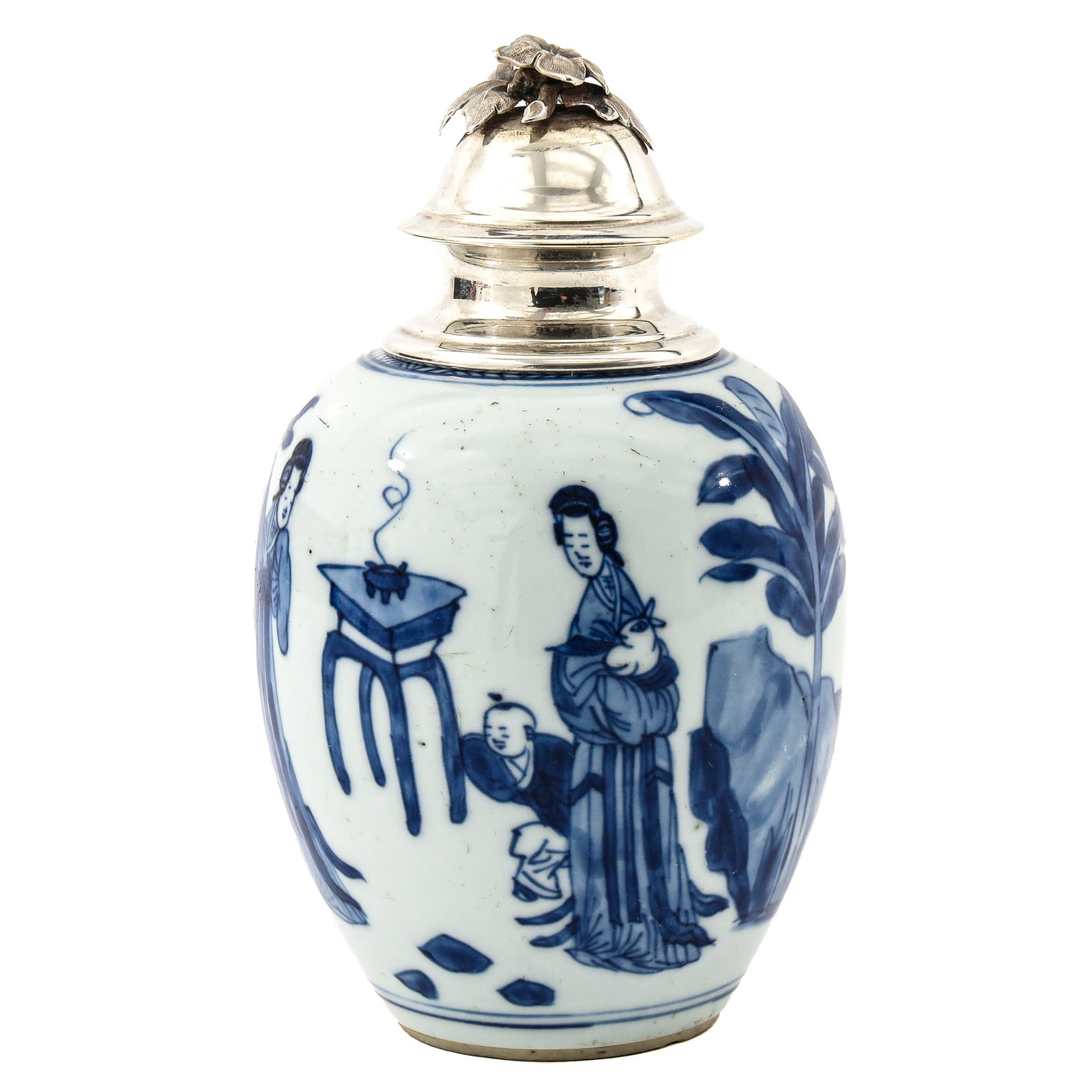 A Blue and White Covered Tea Caddy: Depicting diverse scenes in a garden with Chinese ladies and children, with silver mounting and cover, Kangxi Period, 16 cm tall.